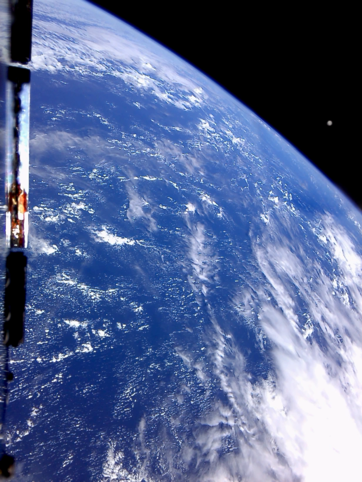 Earth from space with the moon in the distance