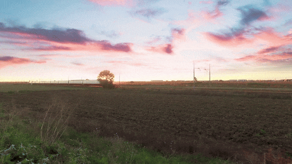 A high-speed train travelling at sunset