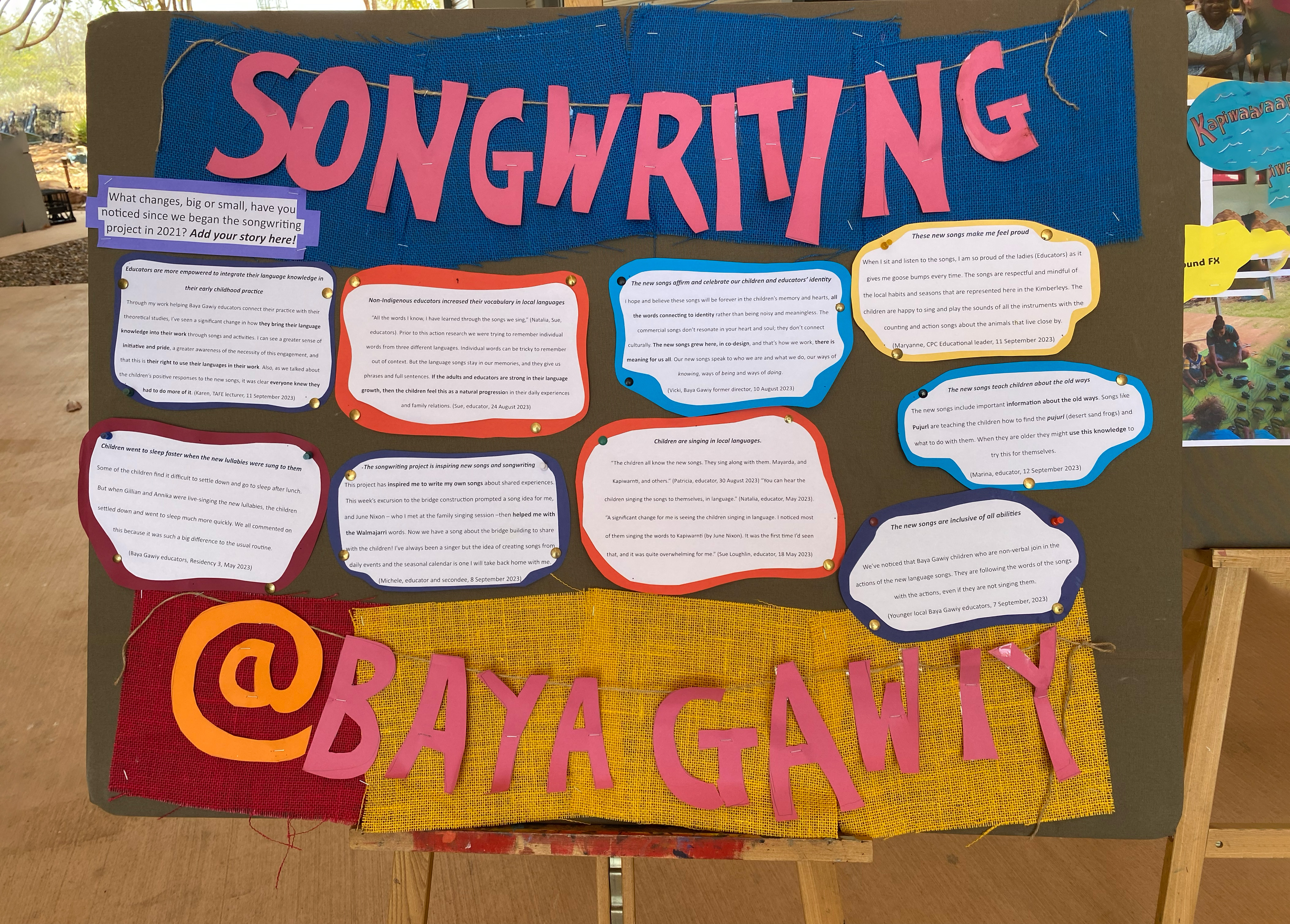 A board with hand-writtten songs pinned to it 