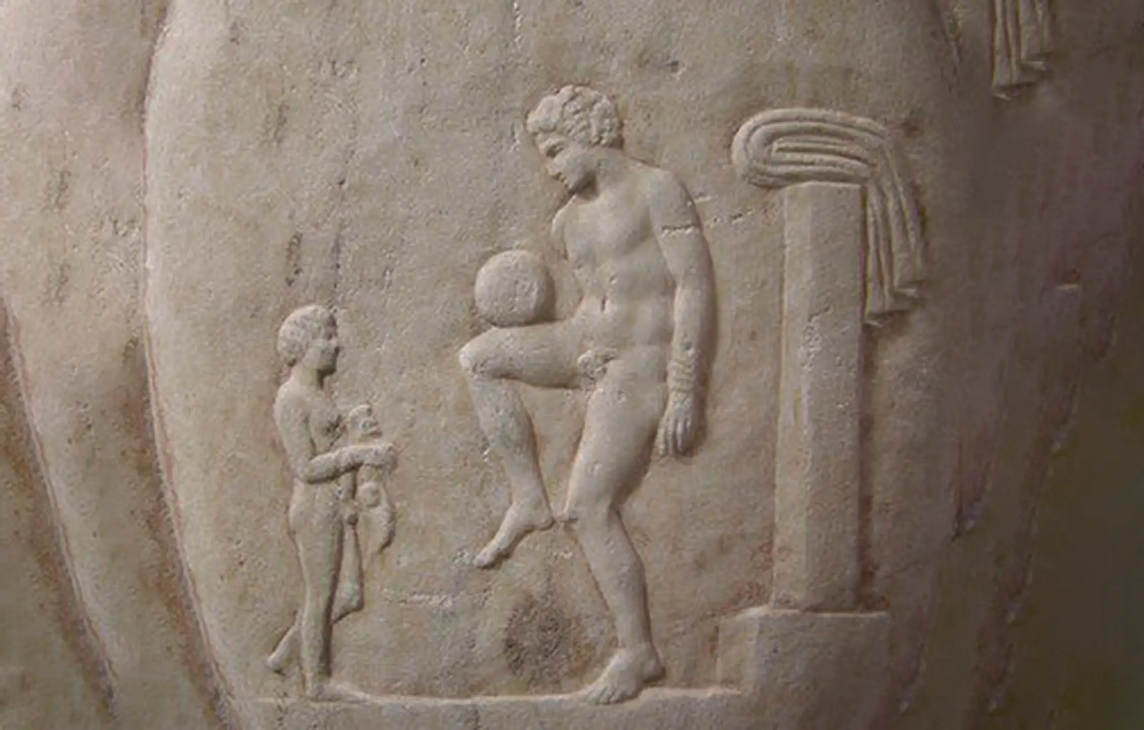 Ancient Greek youth practicing with a ball depicted in low relief