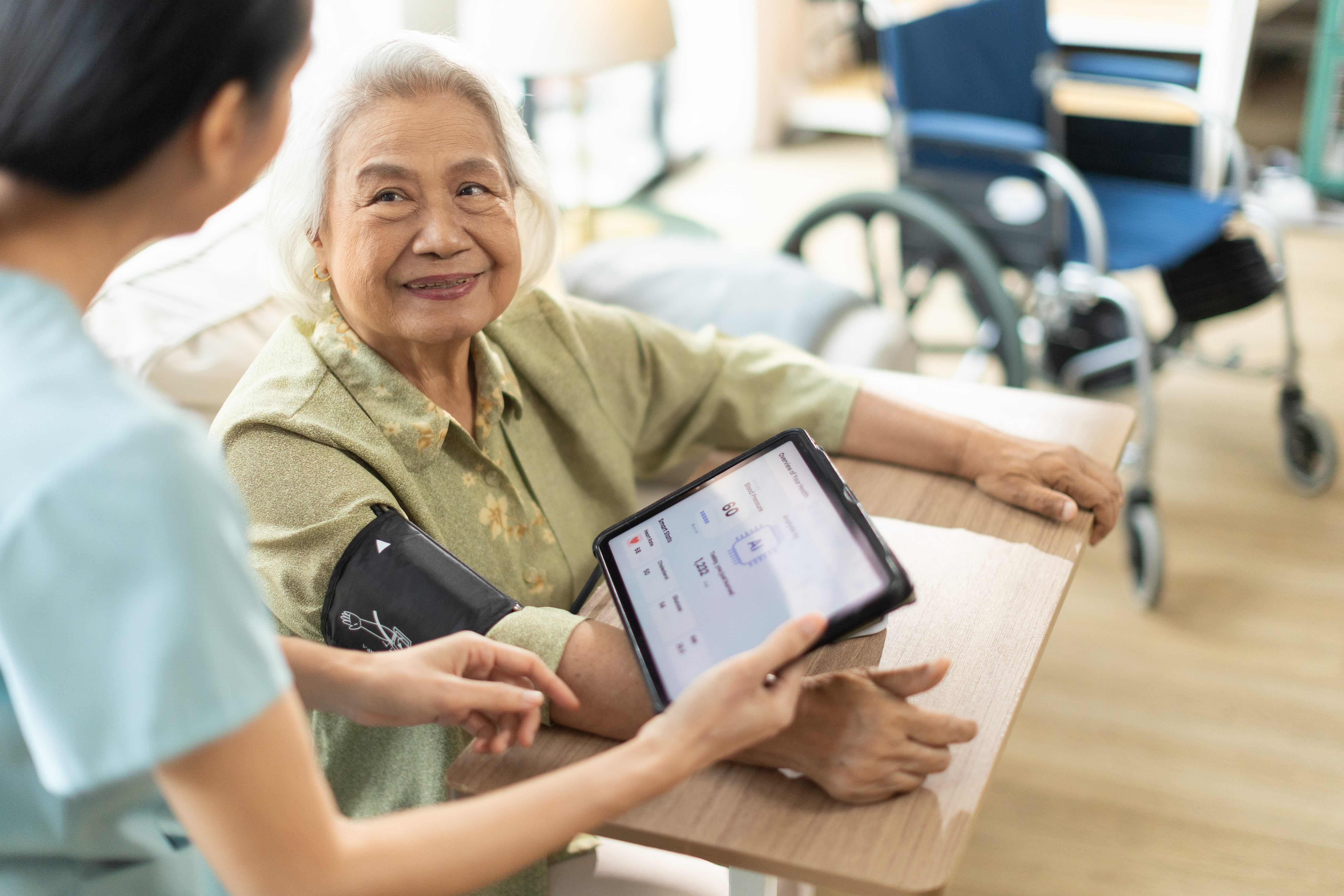 Older woman with nurse and ipad