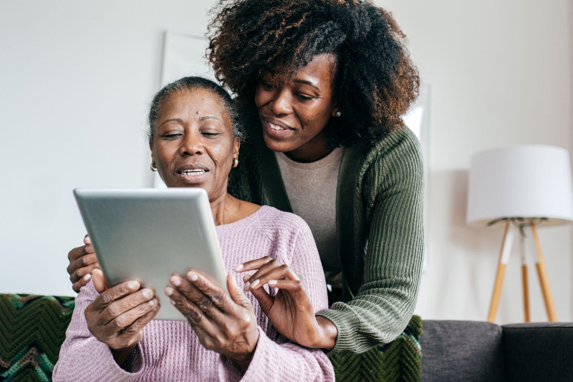 Older mother and her daughter with ipad