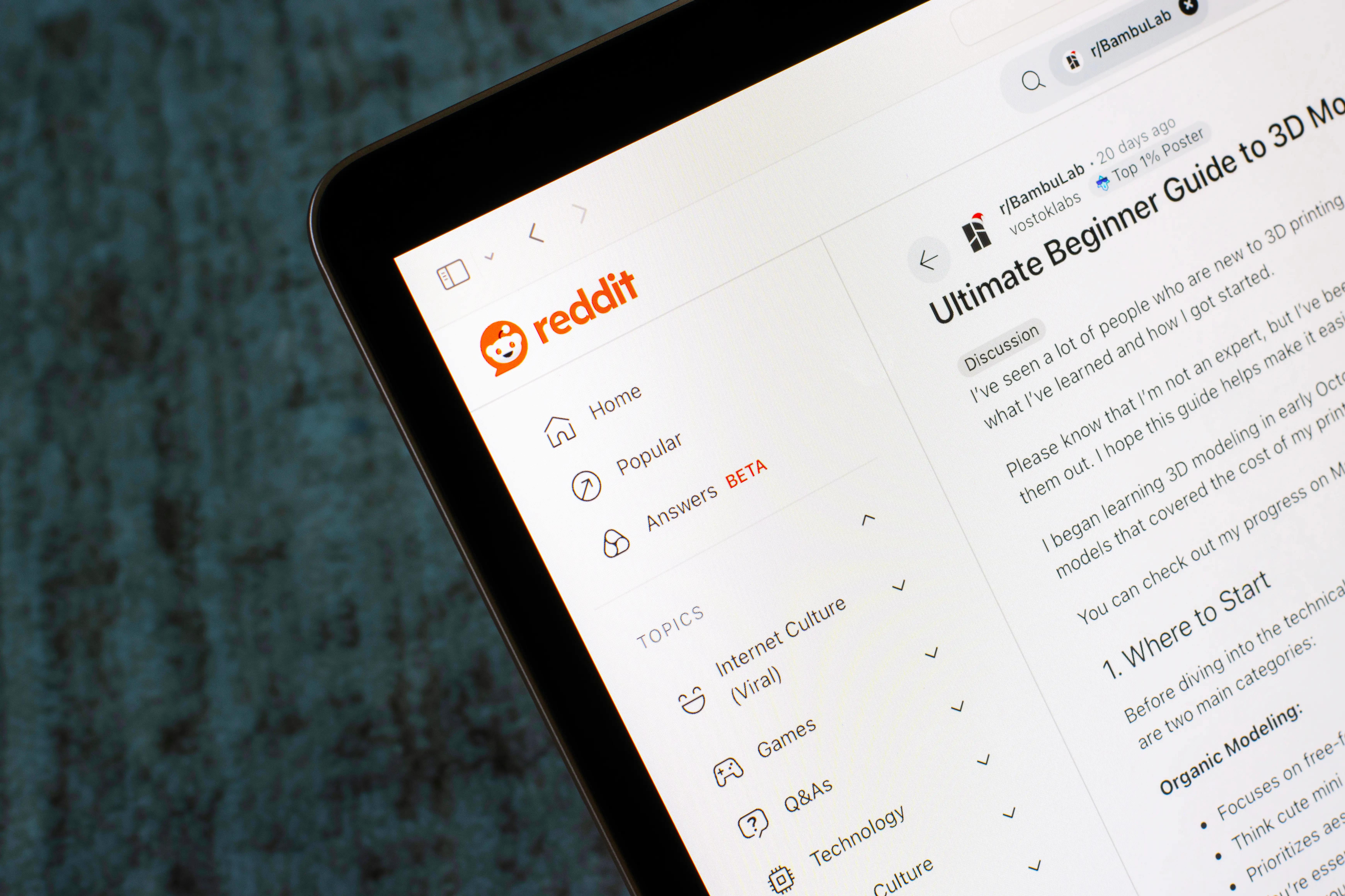 A laptop open on the Reddit homepage 