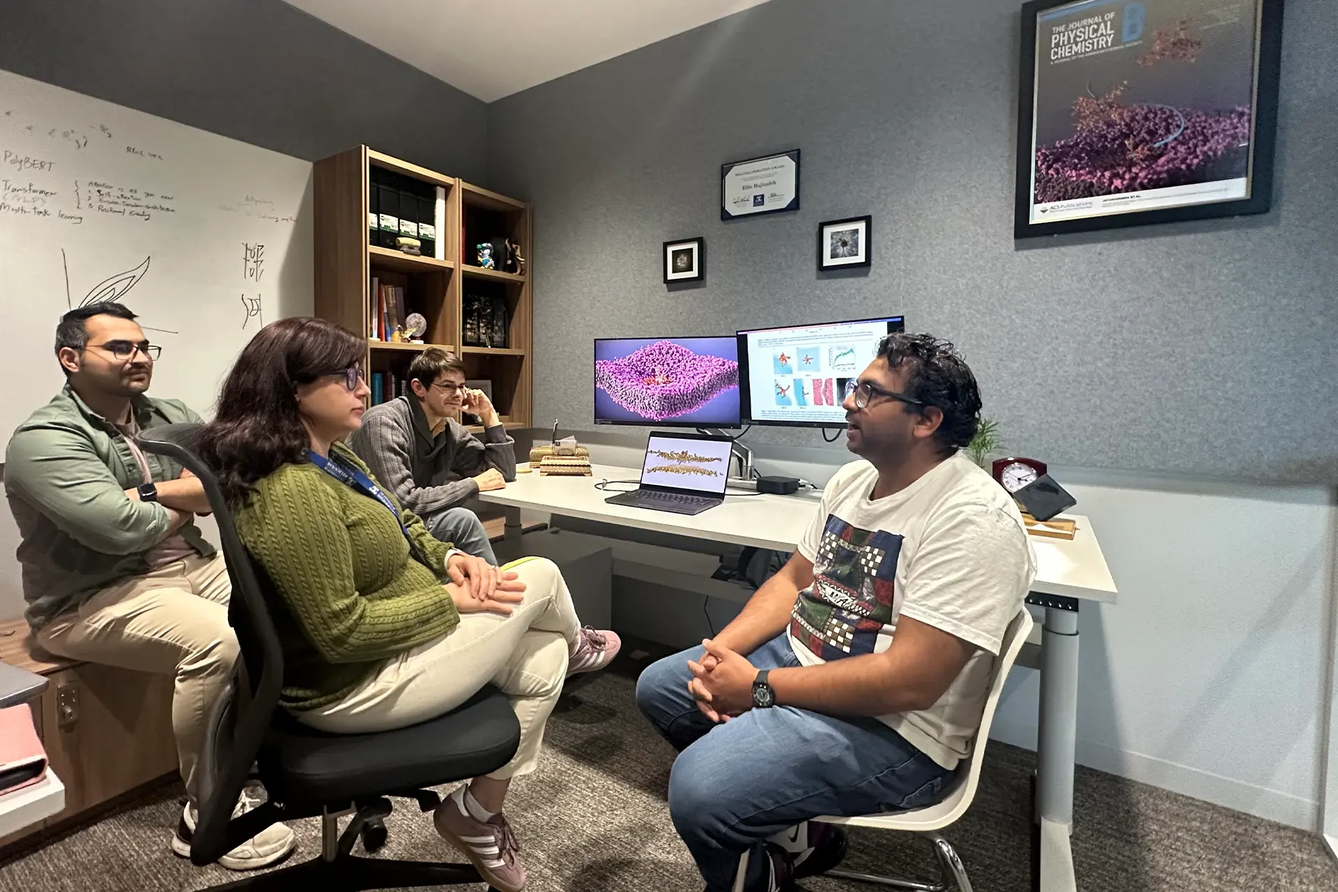Group of people sitting in a small office