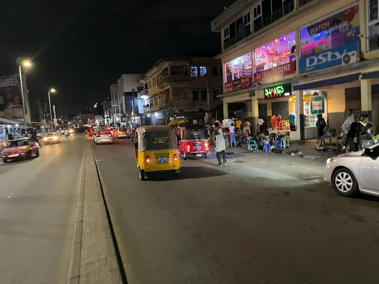 A night view of a busy street in Ghana