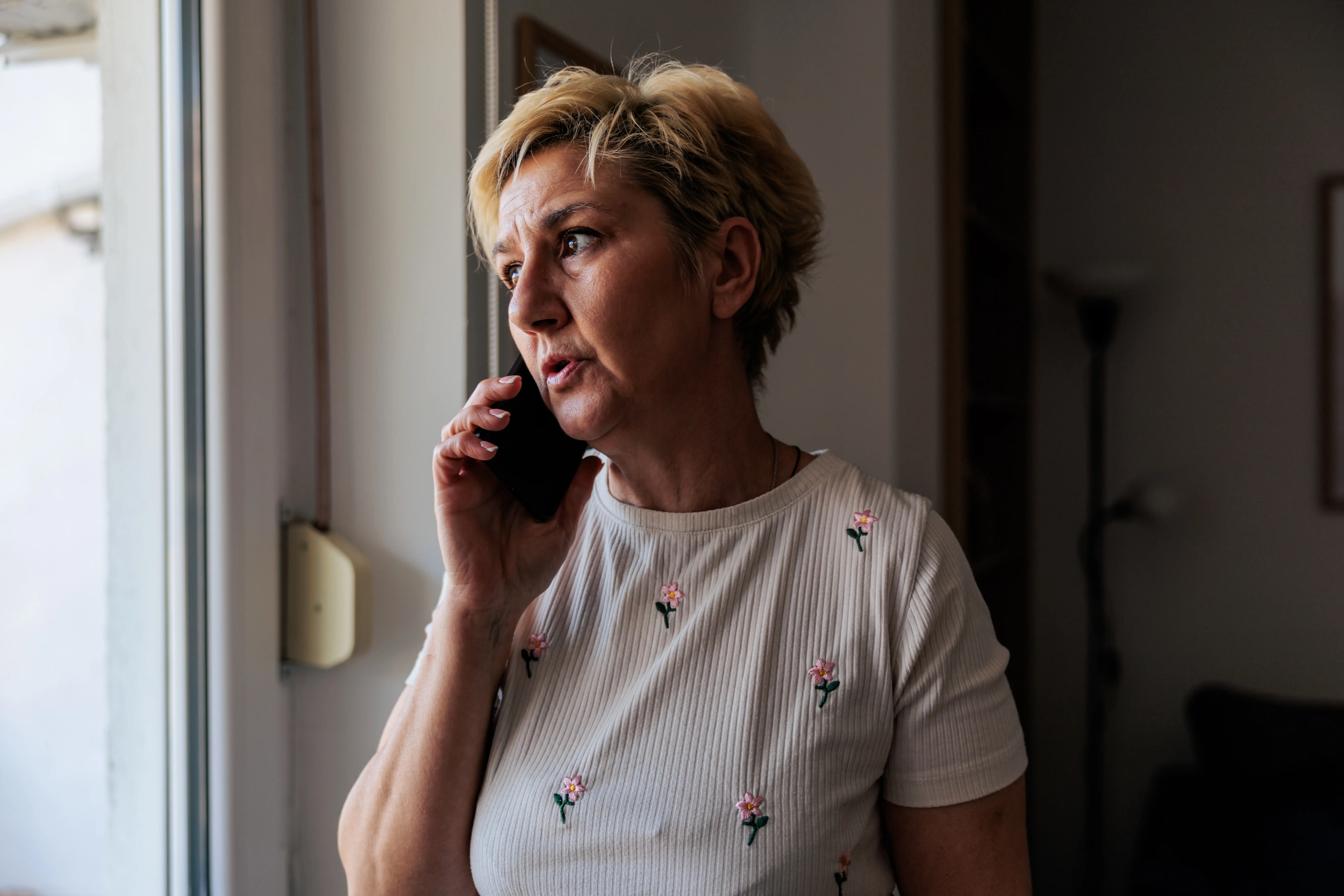 A woman talking seriously on her phone.
