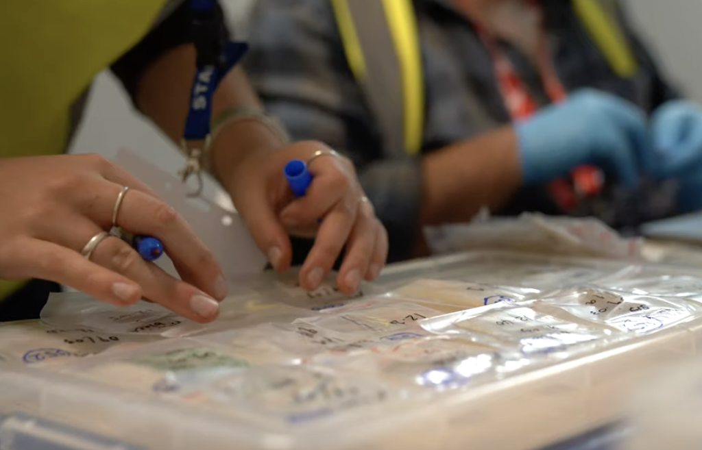 A close up of hand sorting through plastic bags