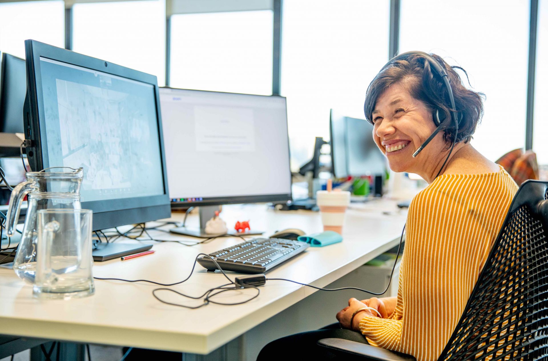 Smiling woman sitting at office desk