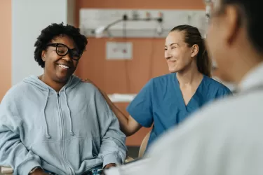 Smiling woman with a doctor and nurse