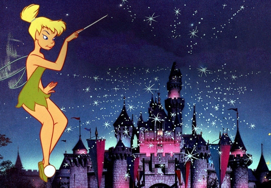 A still of Tinkerbell in front of the Disney castle