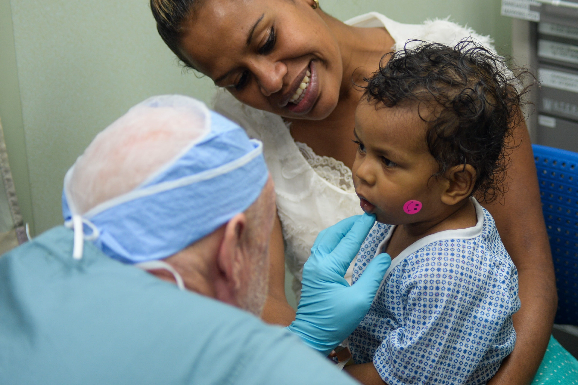 Doctor examining a baby being held by its mother