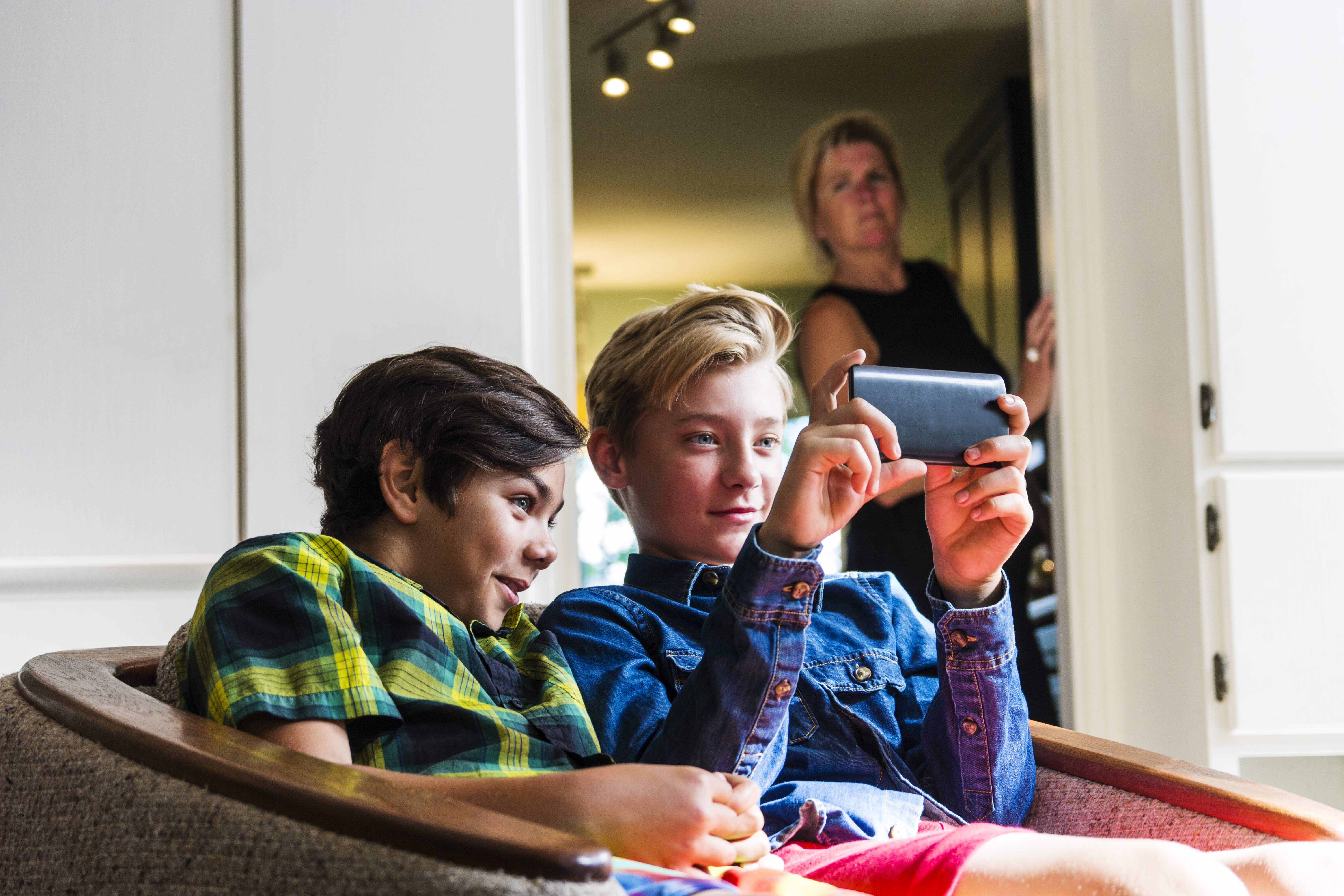 Boys on screen with Mum looking on