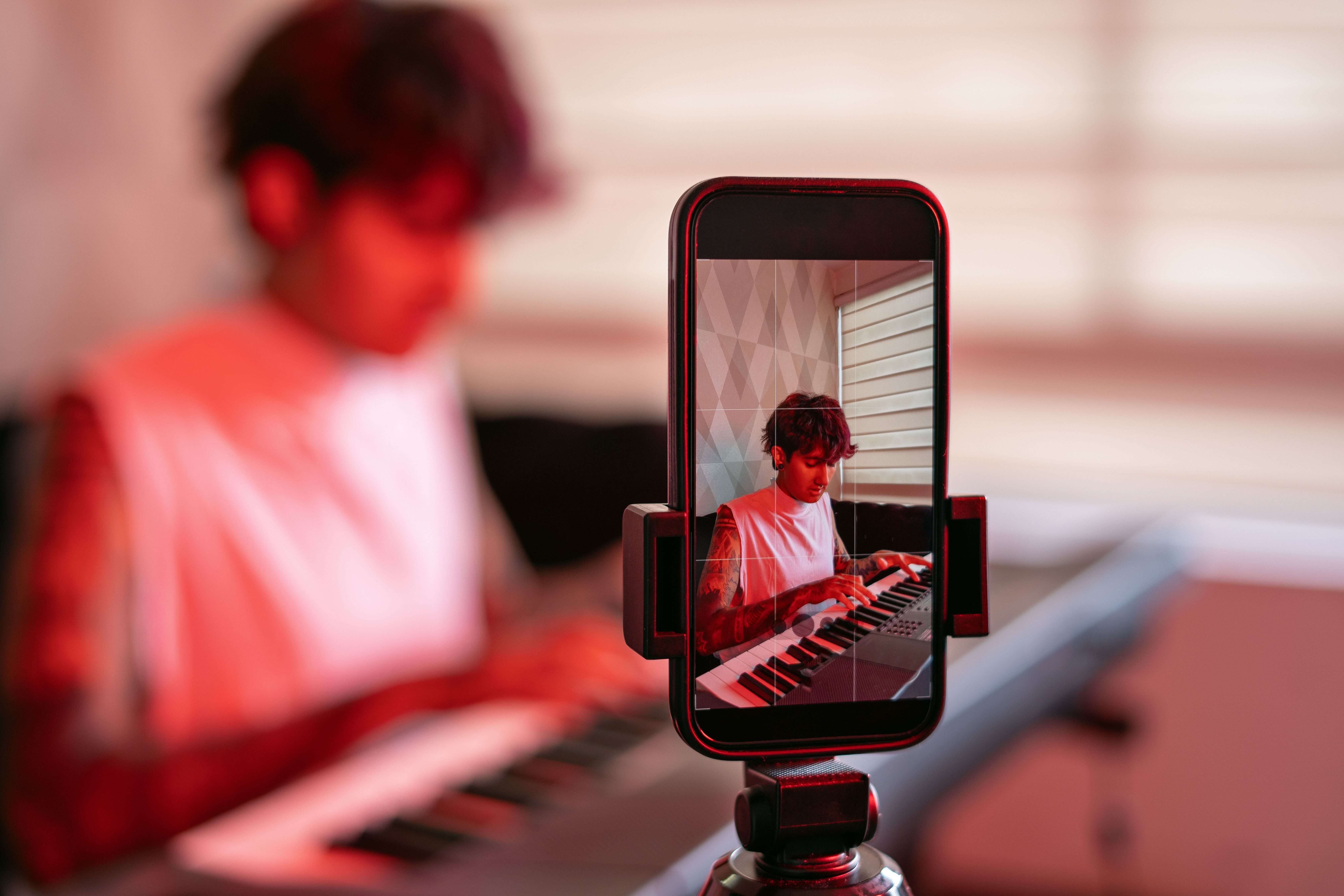 Young man recording on keyboard