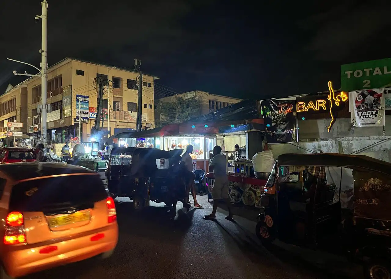 A night view of a busy street in Ghana
