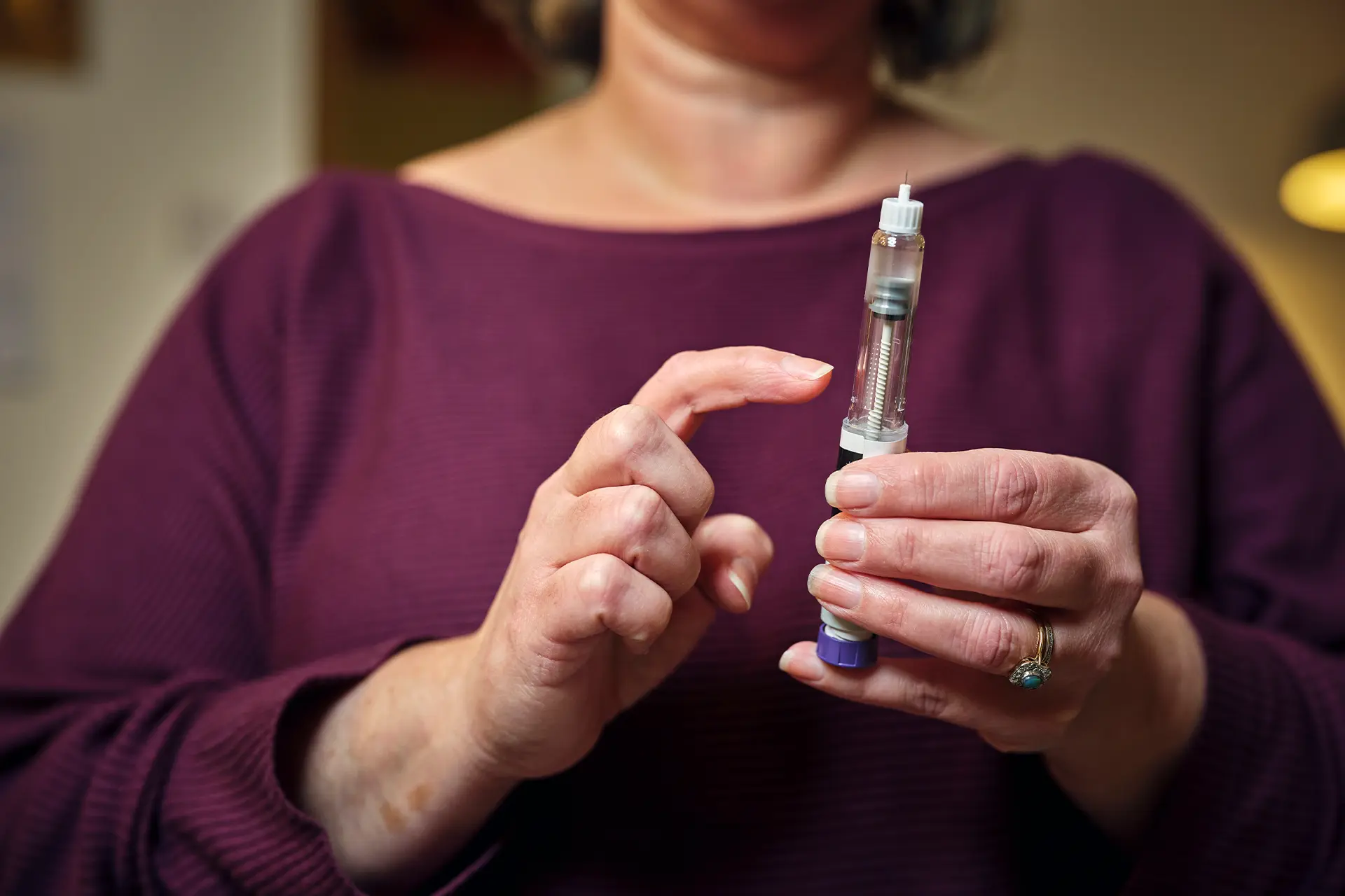 Woman holding a weightloss injection device