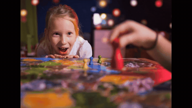 A young kid playing a boardgame