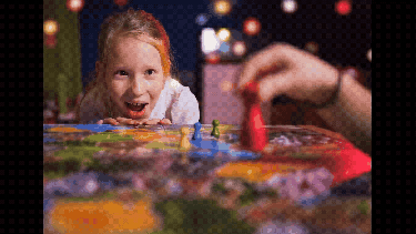 A young kid playing a boardgame
