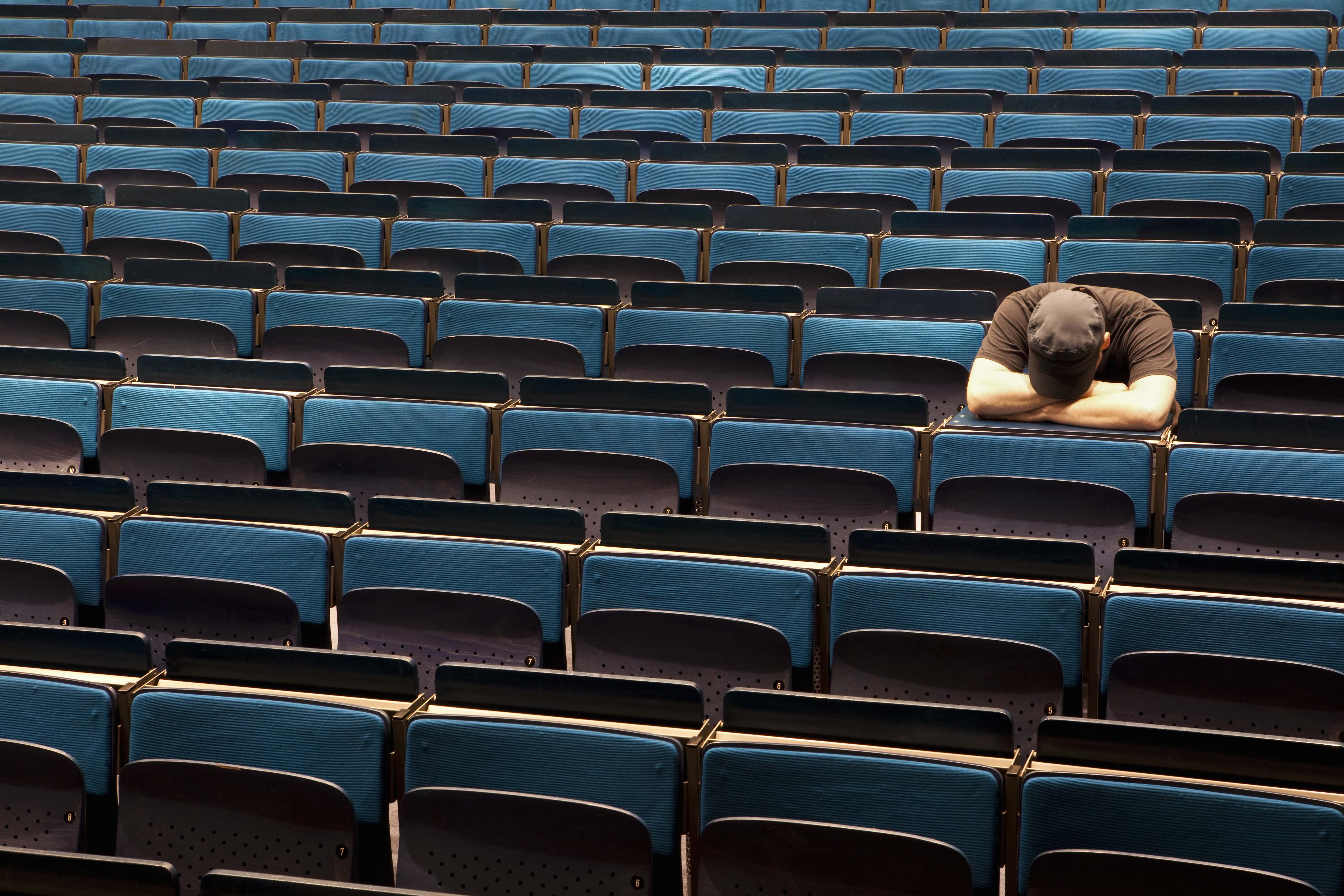 Single student asleep in lecture