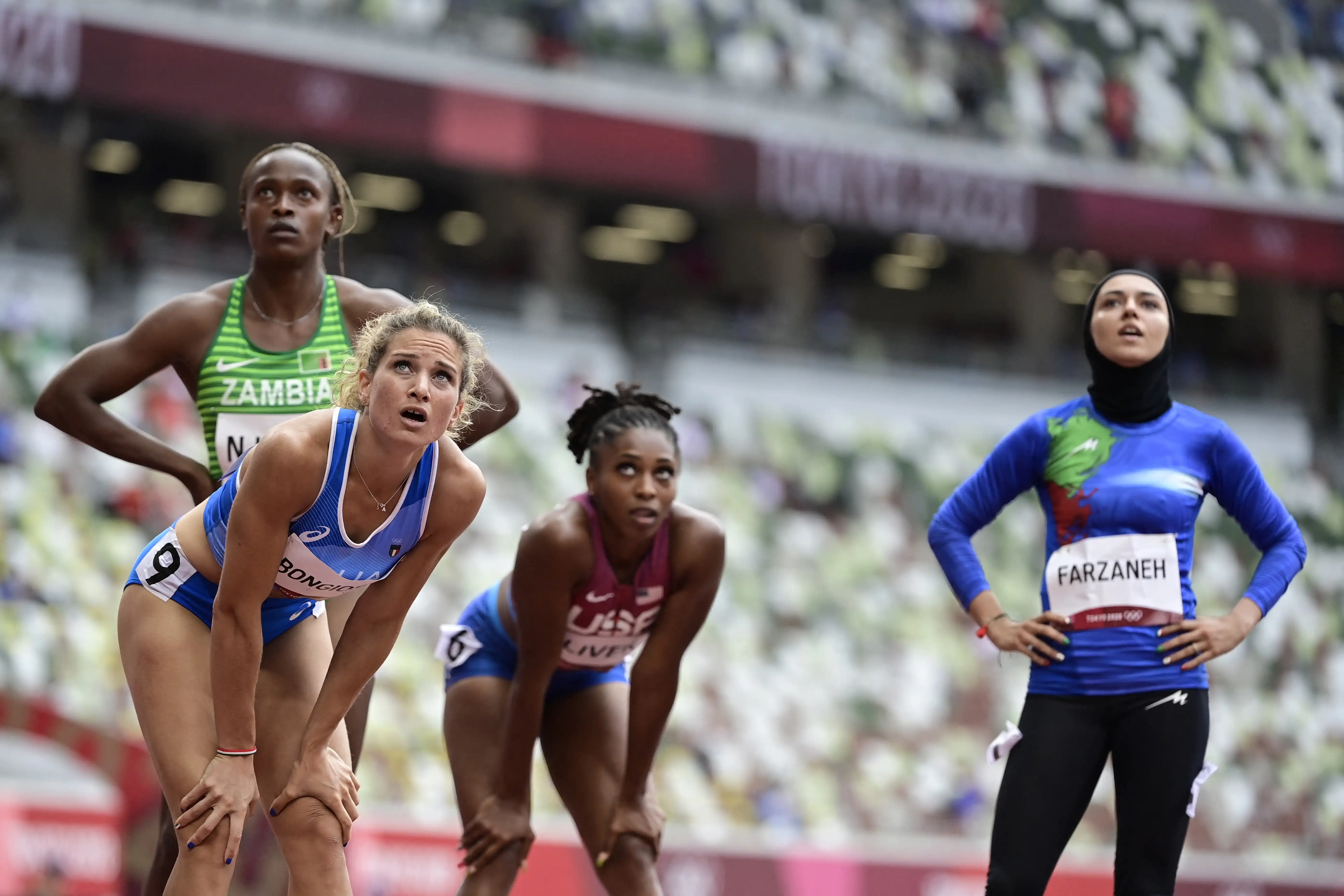 Female athletes catch their breath after a race during the Olympics