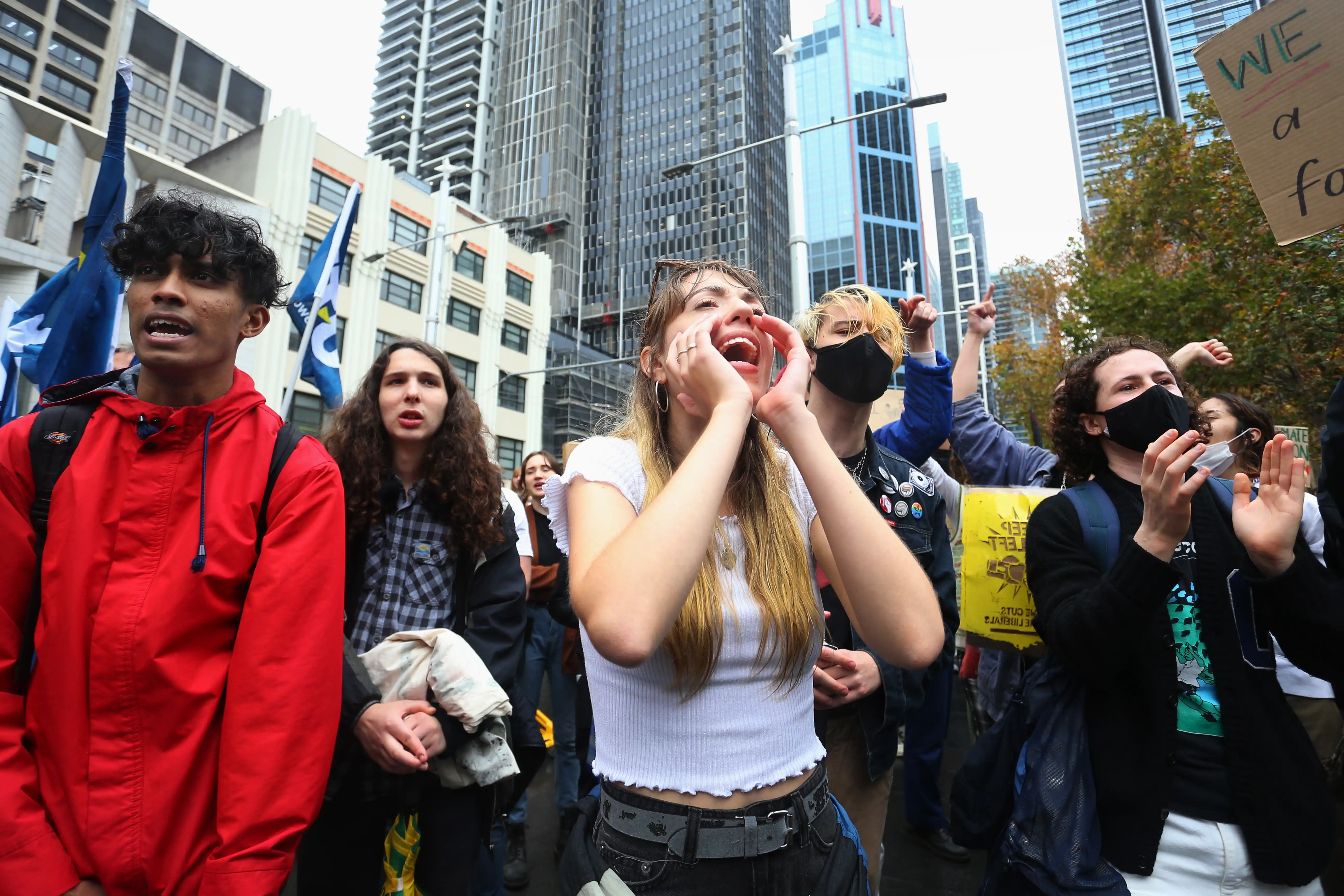 Young people call out chants and hold signs at a protest in the city