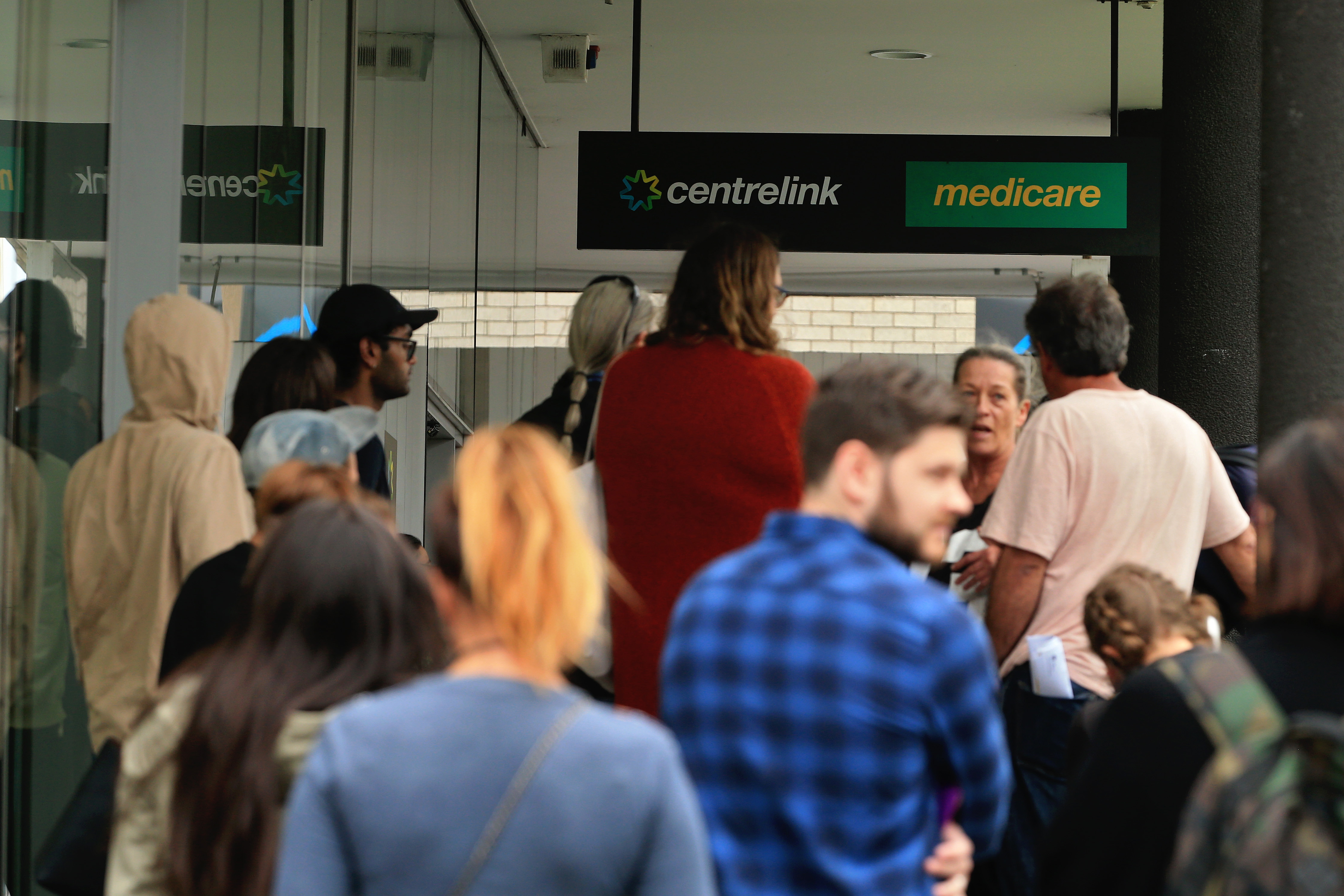 A photo of a queue outside a Medicare and Centrelink office