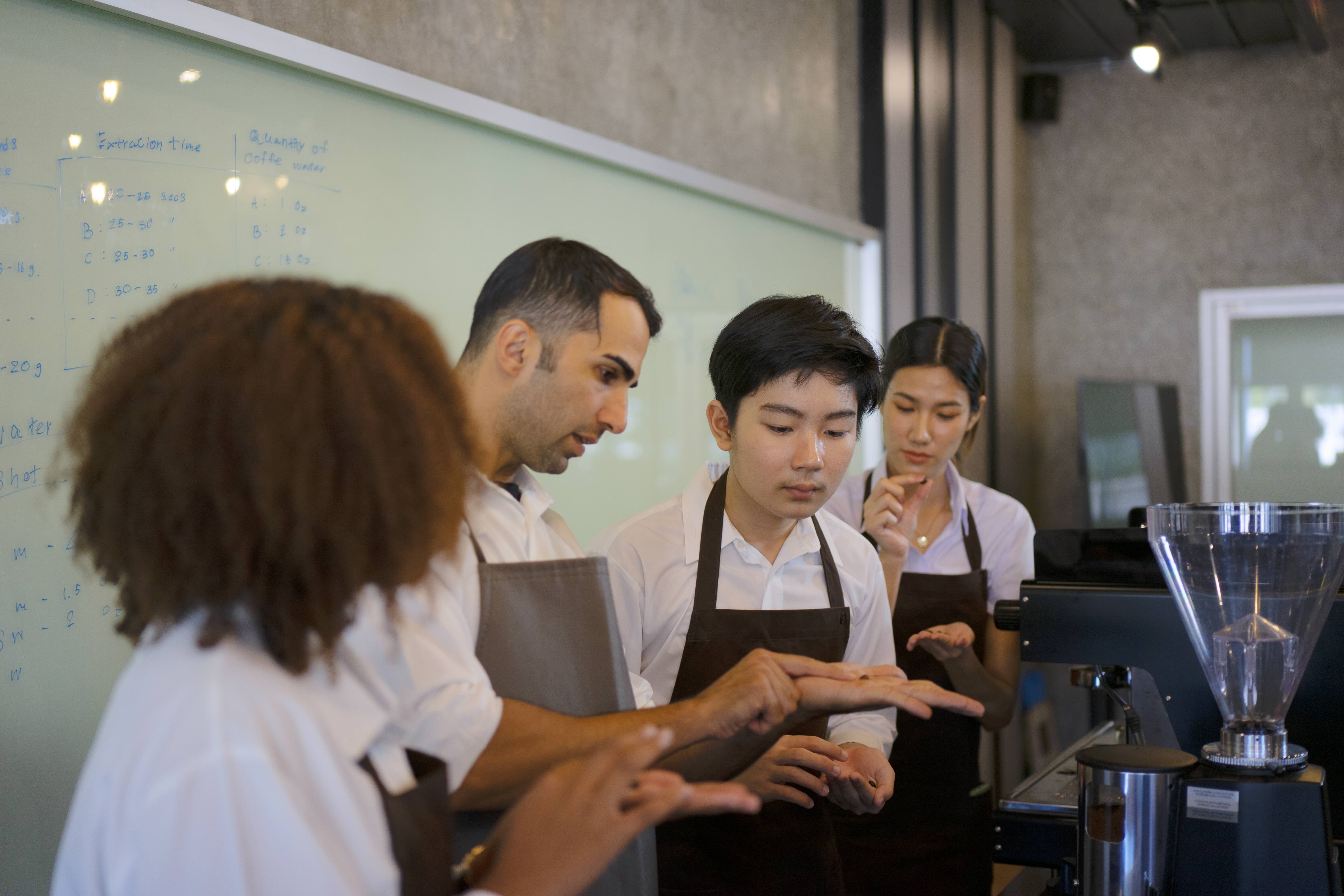 Teens learning from barista