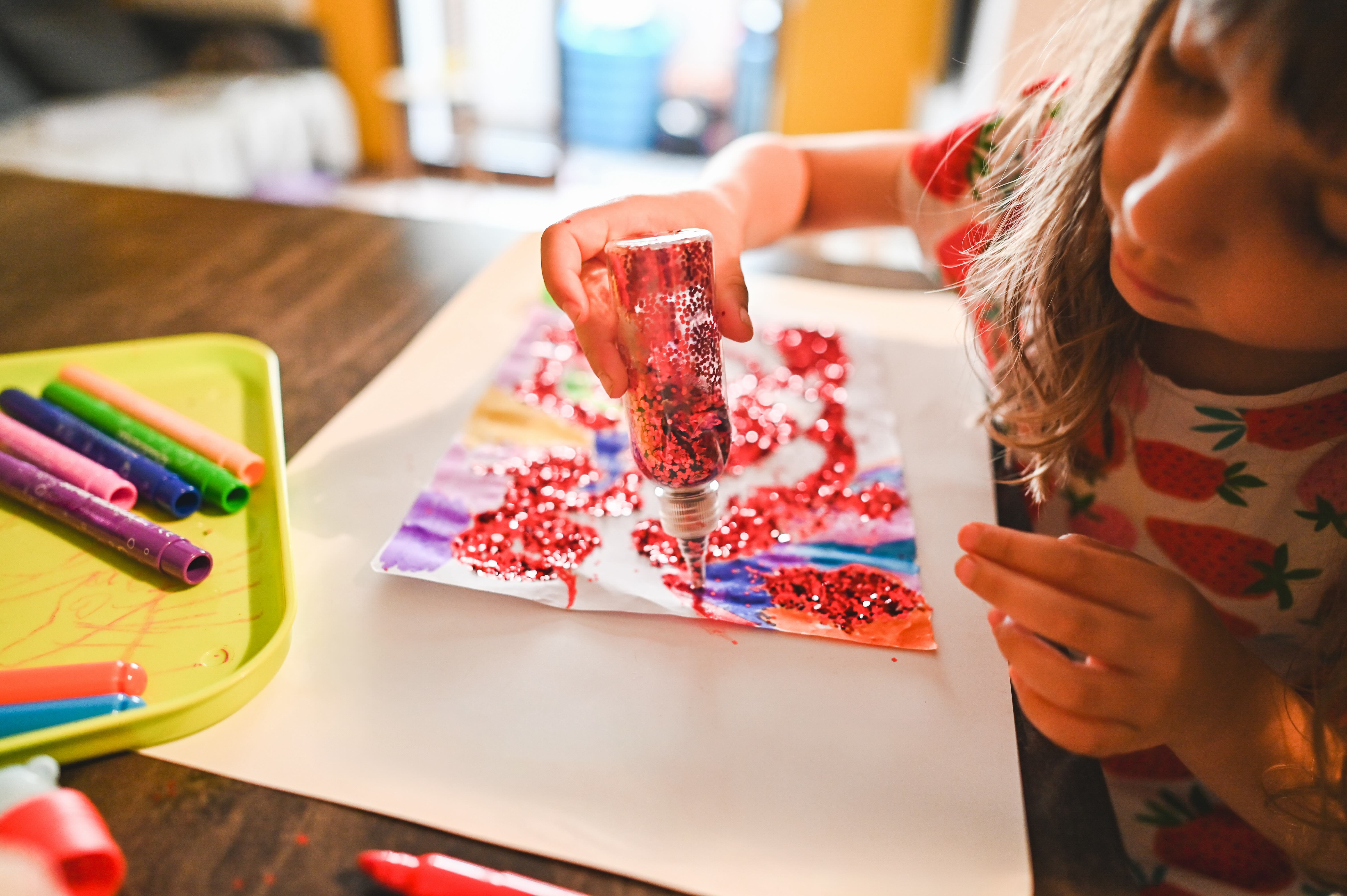 Child and glitter craft