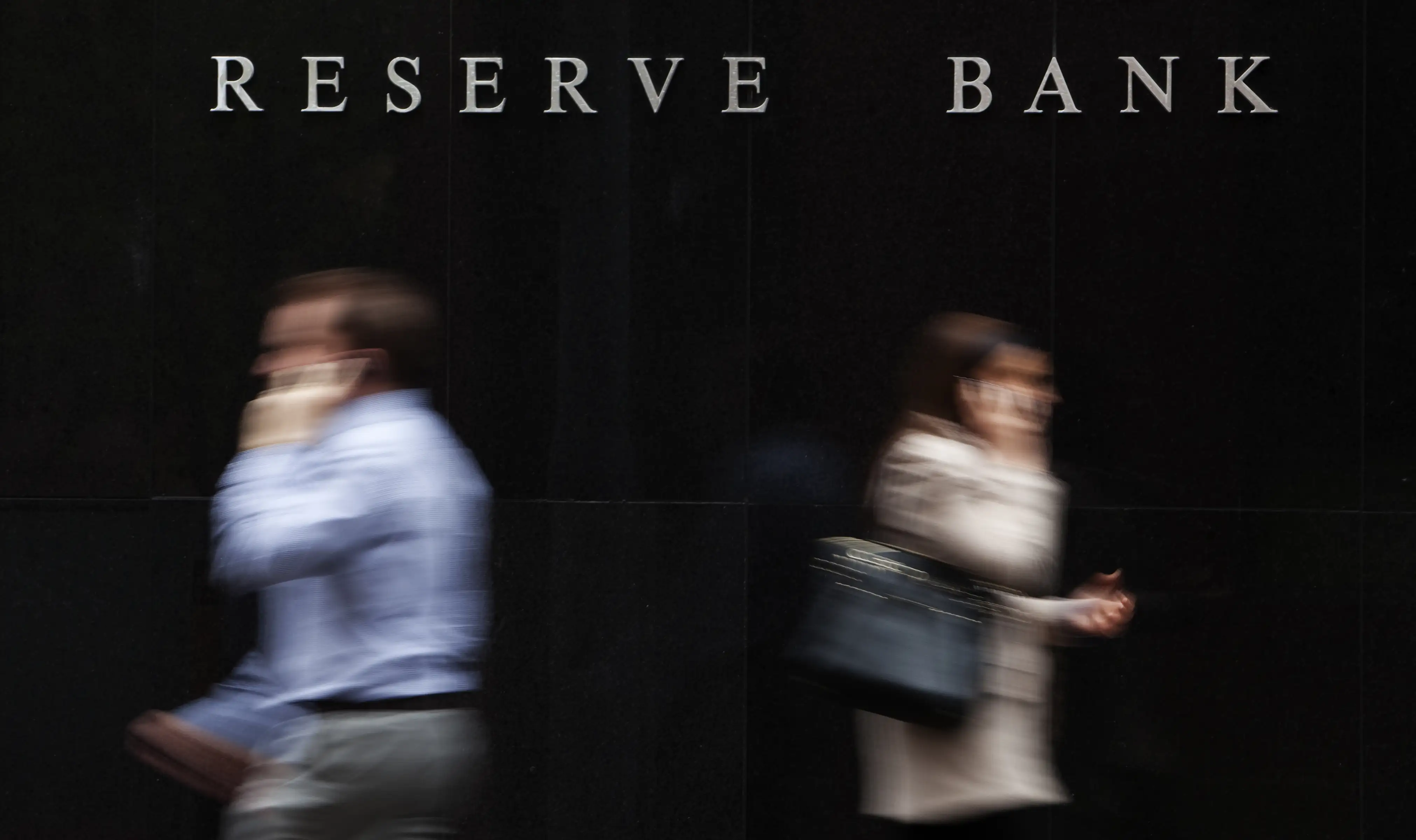 People walking past the Reserve Bank of Australia in Sydney