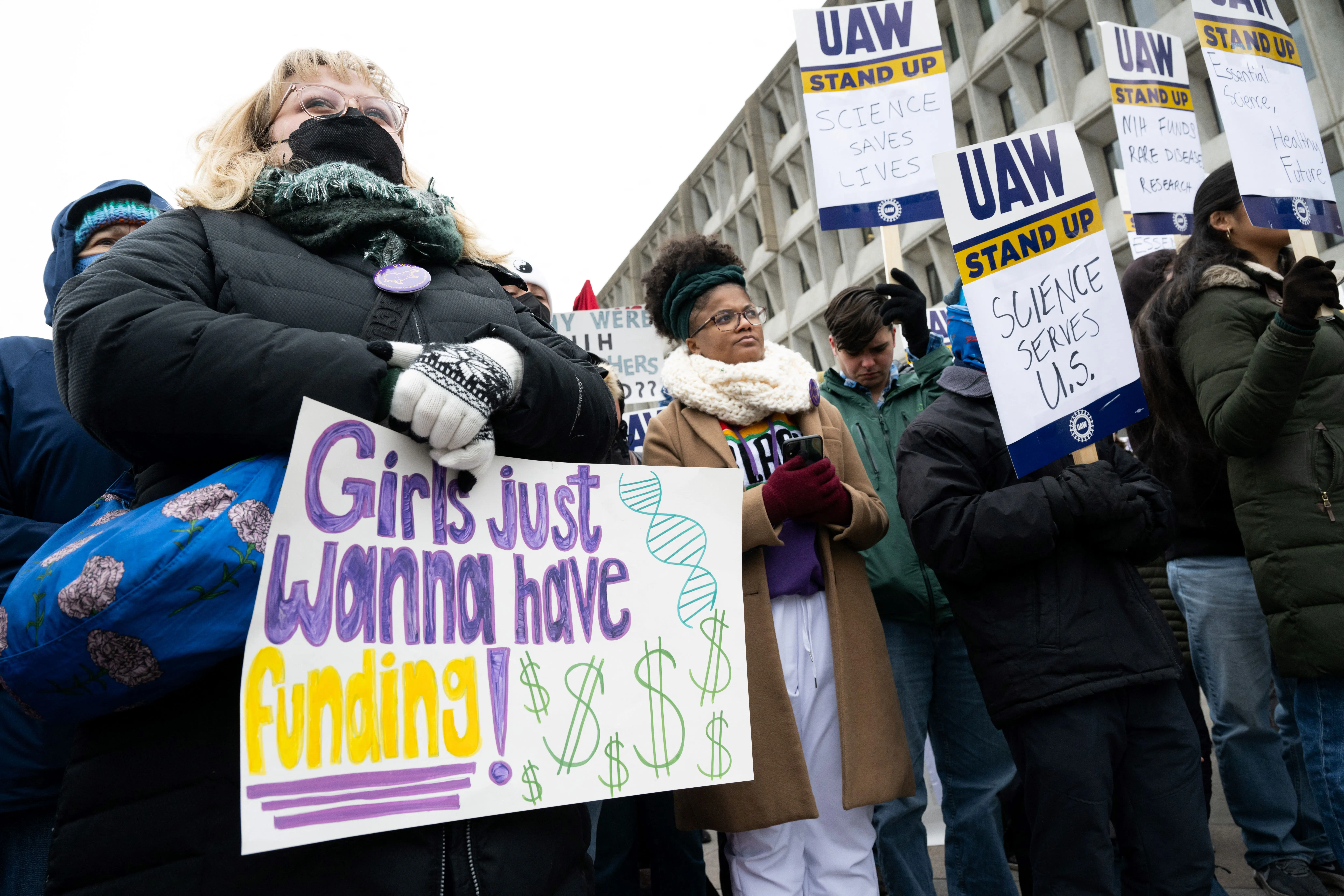 Demonstrators attend a protest against US President Donald Trump and Elon Musk's DOGE cuts to medical research and higher education