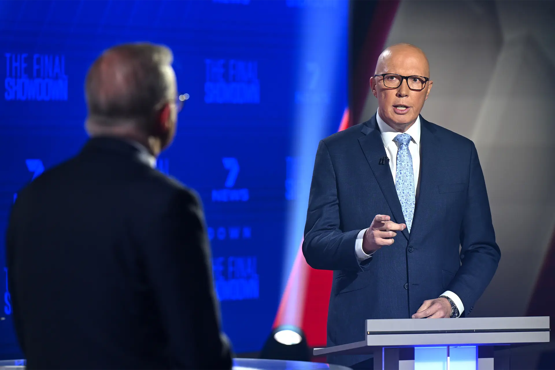 Opposition Leader Peter Dutton speaks while Prime Minister Anthony Albanese looks on during the final leaders' debate