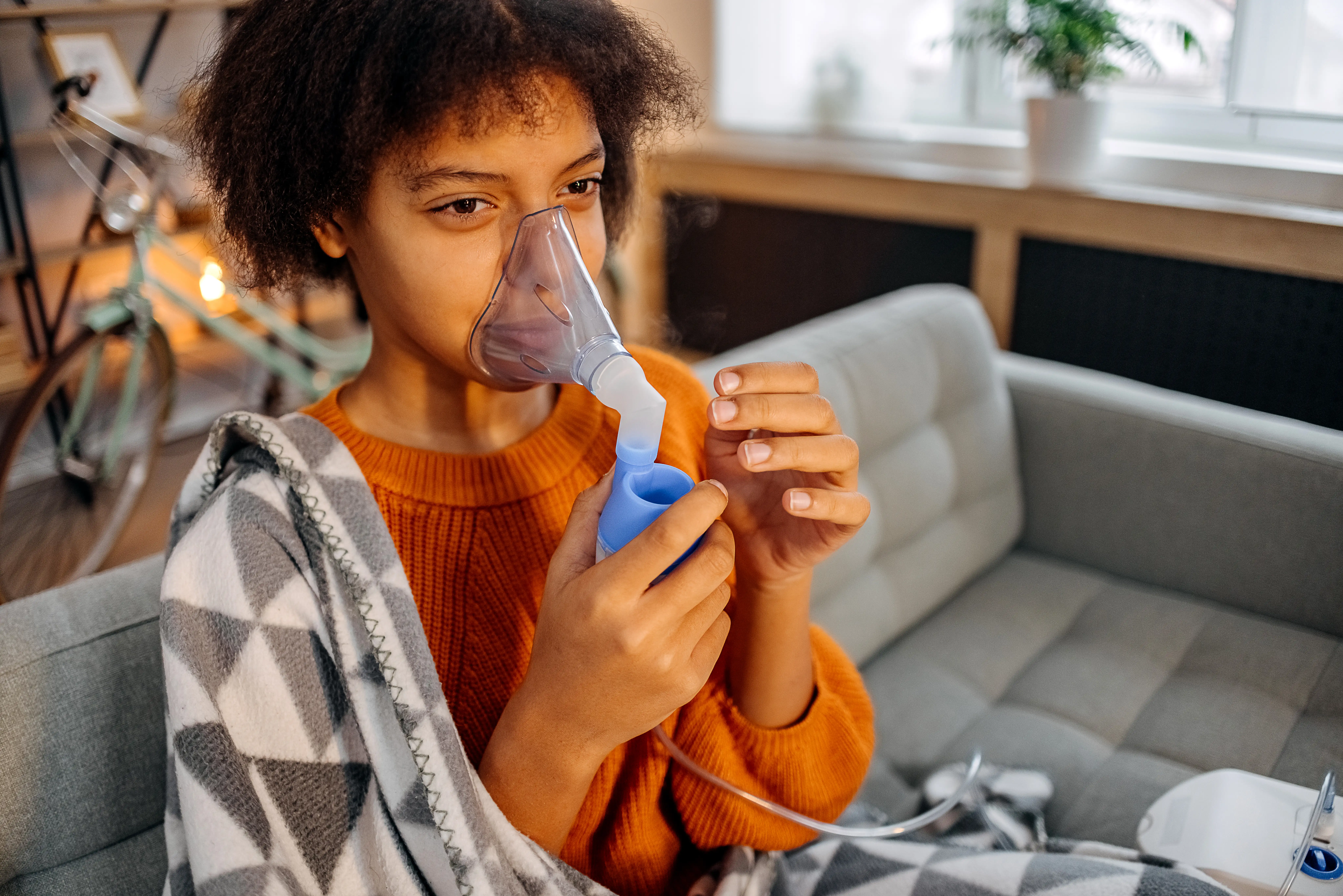A teenager using a nebuliser to treat asthma