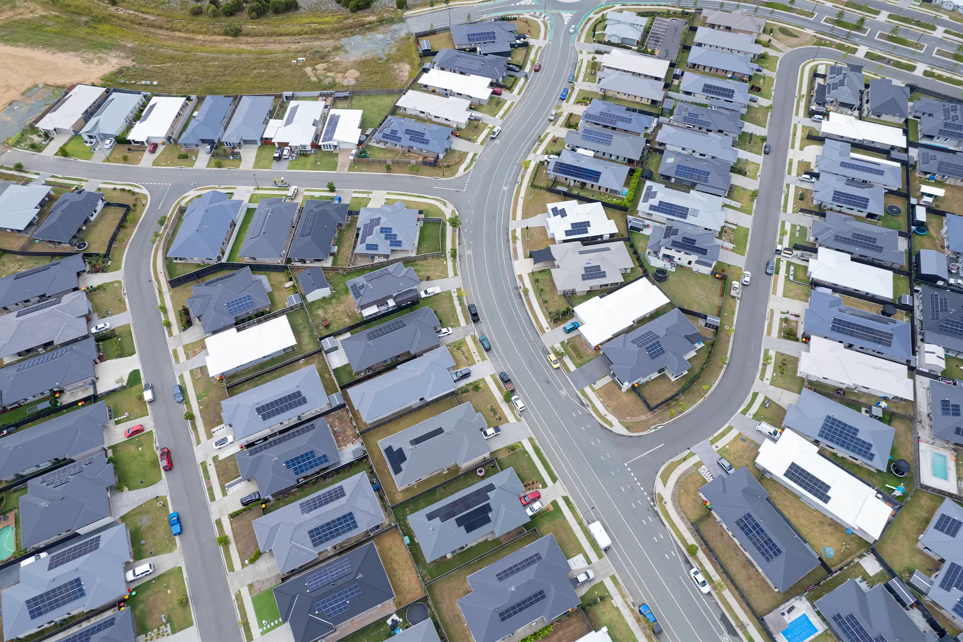 Overhead shot of a new housing estate and many of the roofs have solar panels