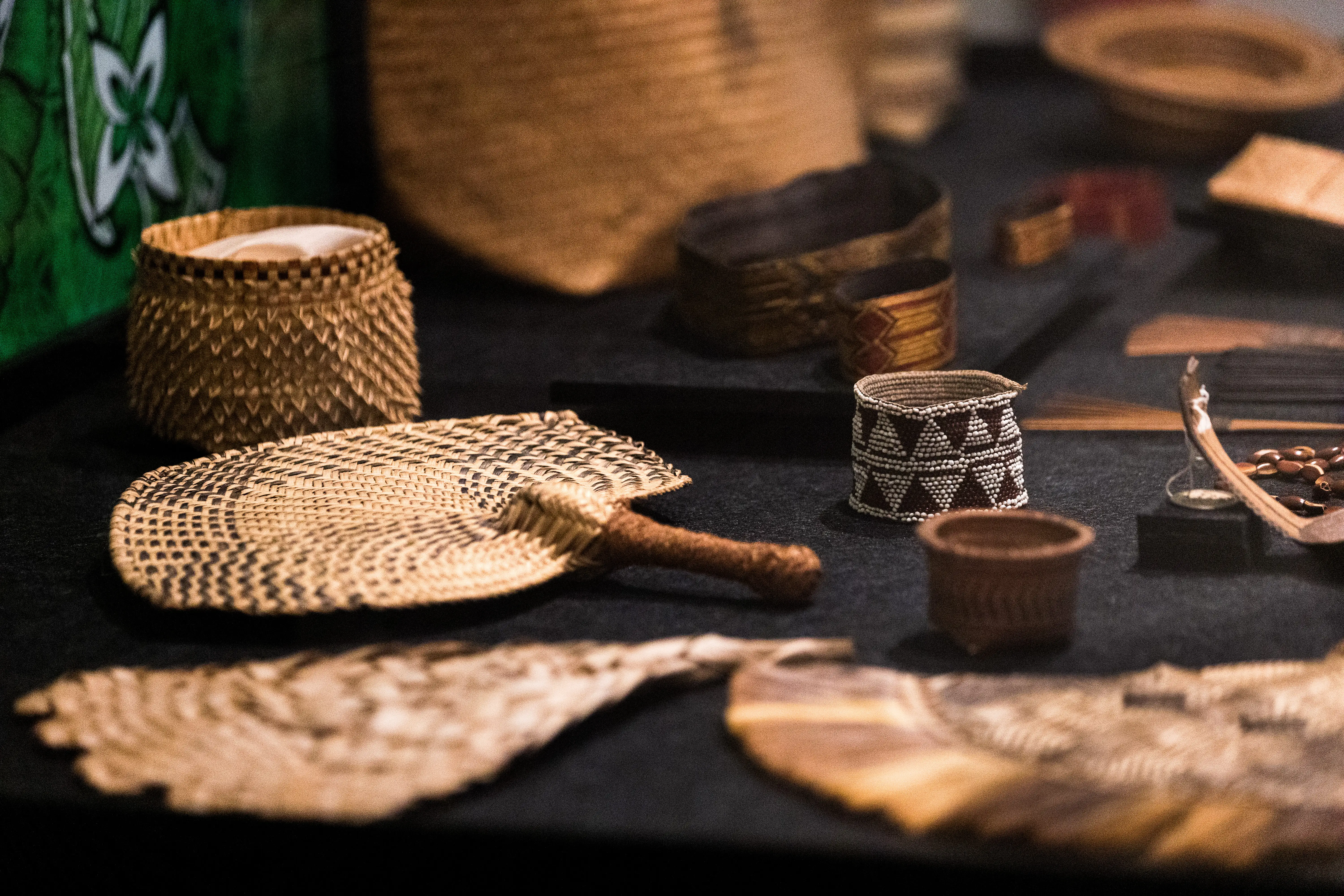 Woven Pacific objects on a table in the Grainger Museum 