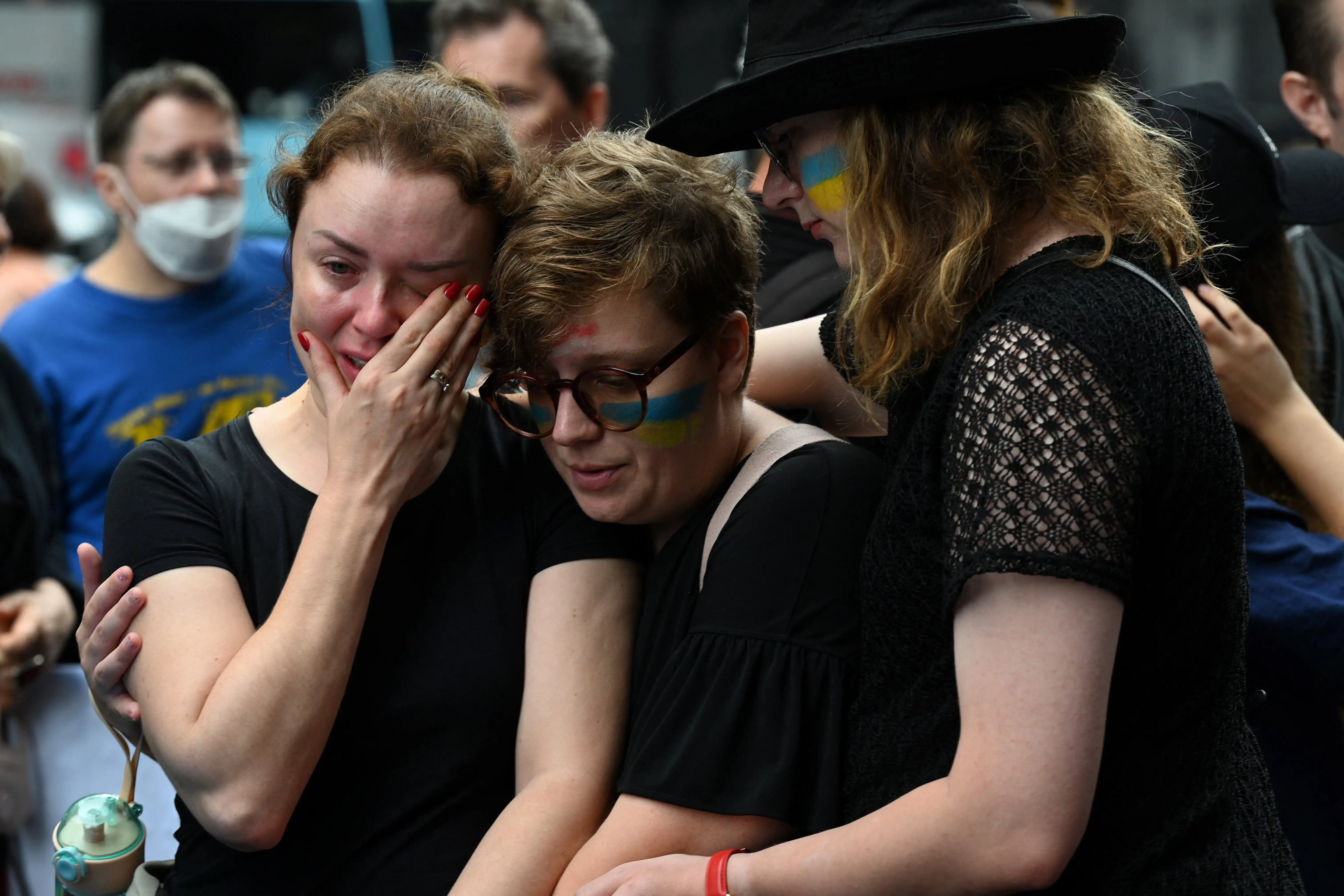 Protesters shed tears at a gathering against the Russian war in Ukraine
