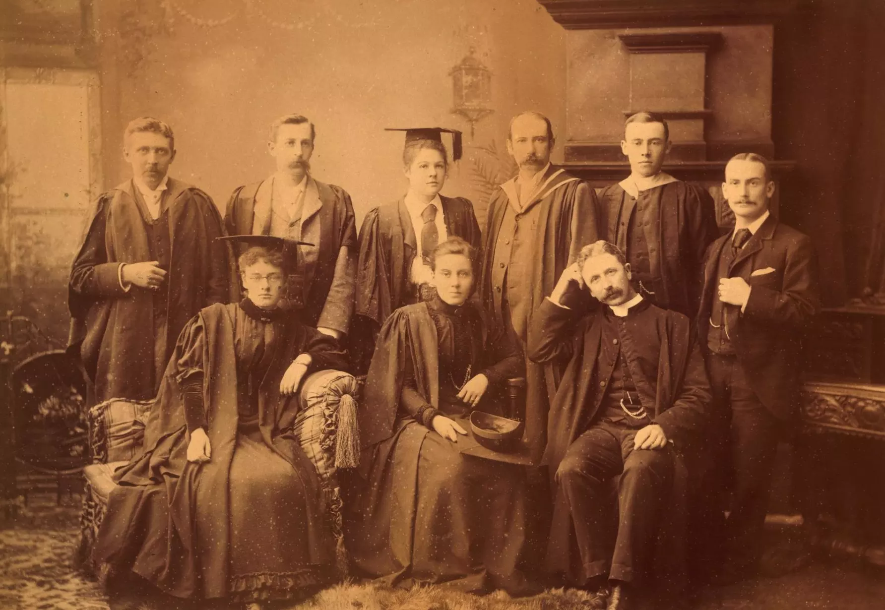 A sepia portrait of of nine staff and students