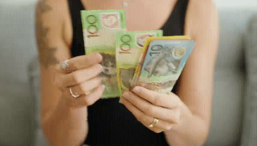A woman counting Australian dollars