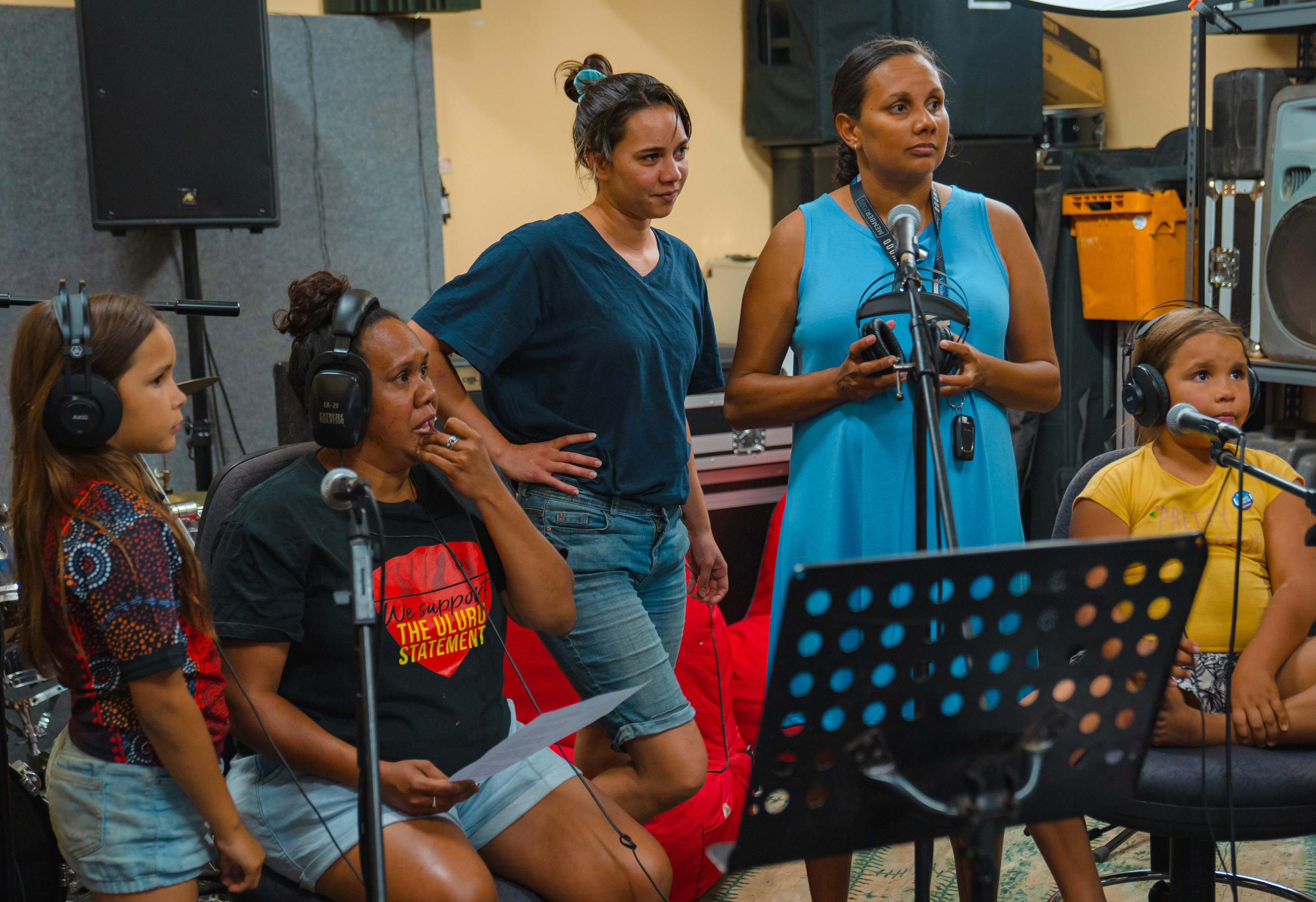 A group of women and children in front of microphones