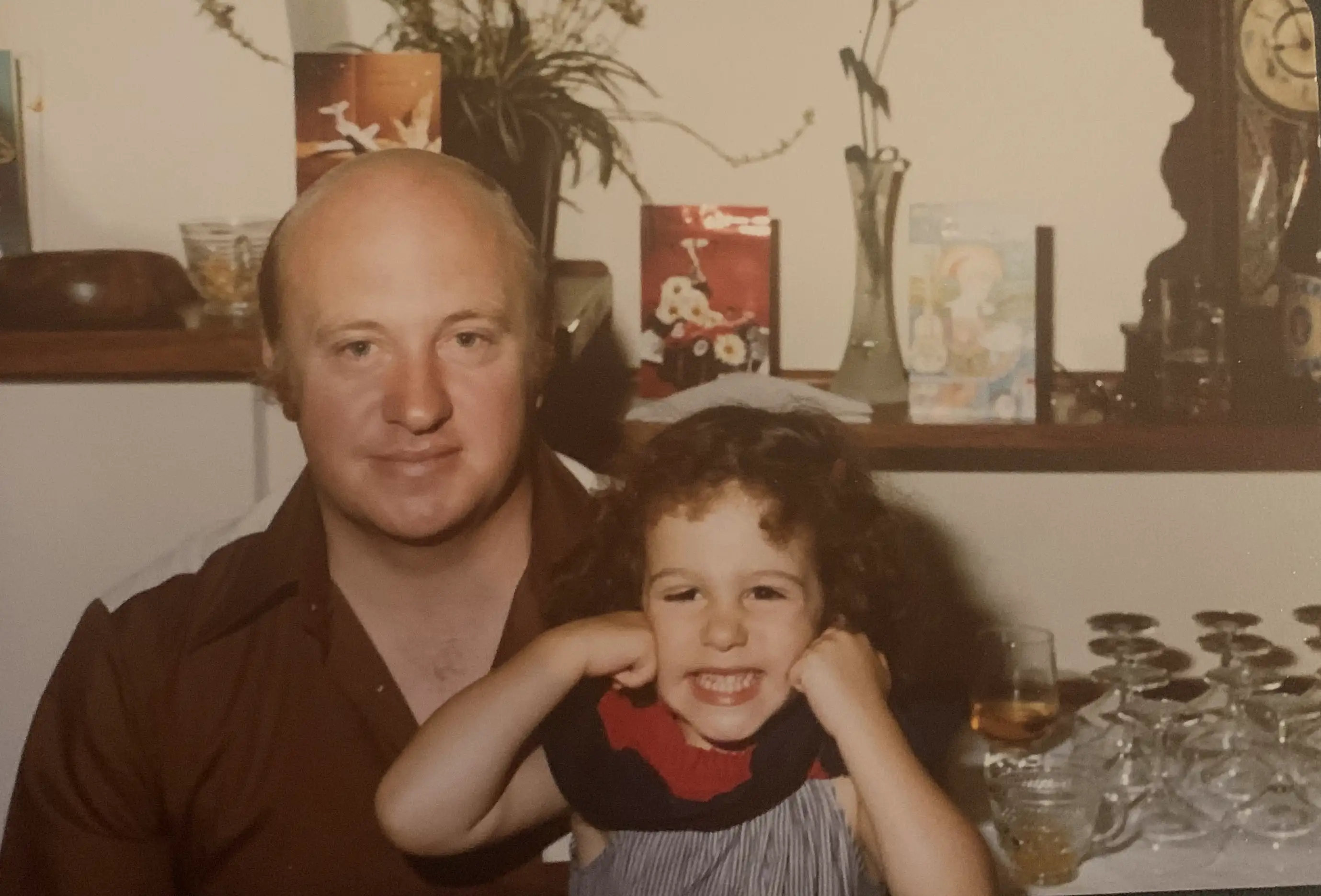 A photo of the author's father with her as a young child