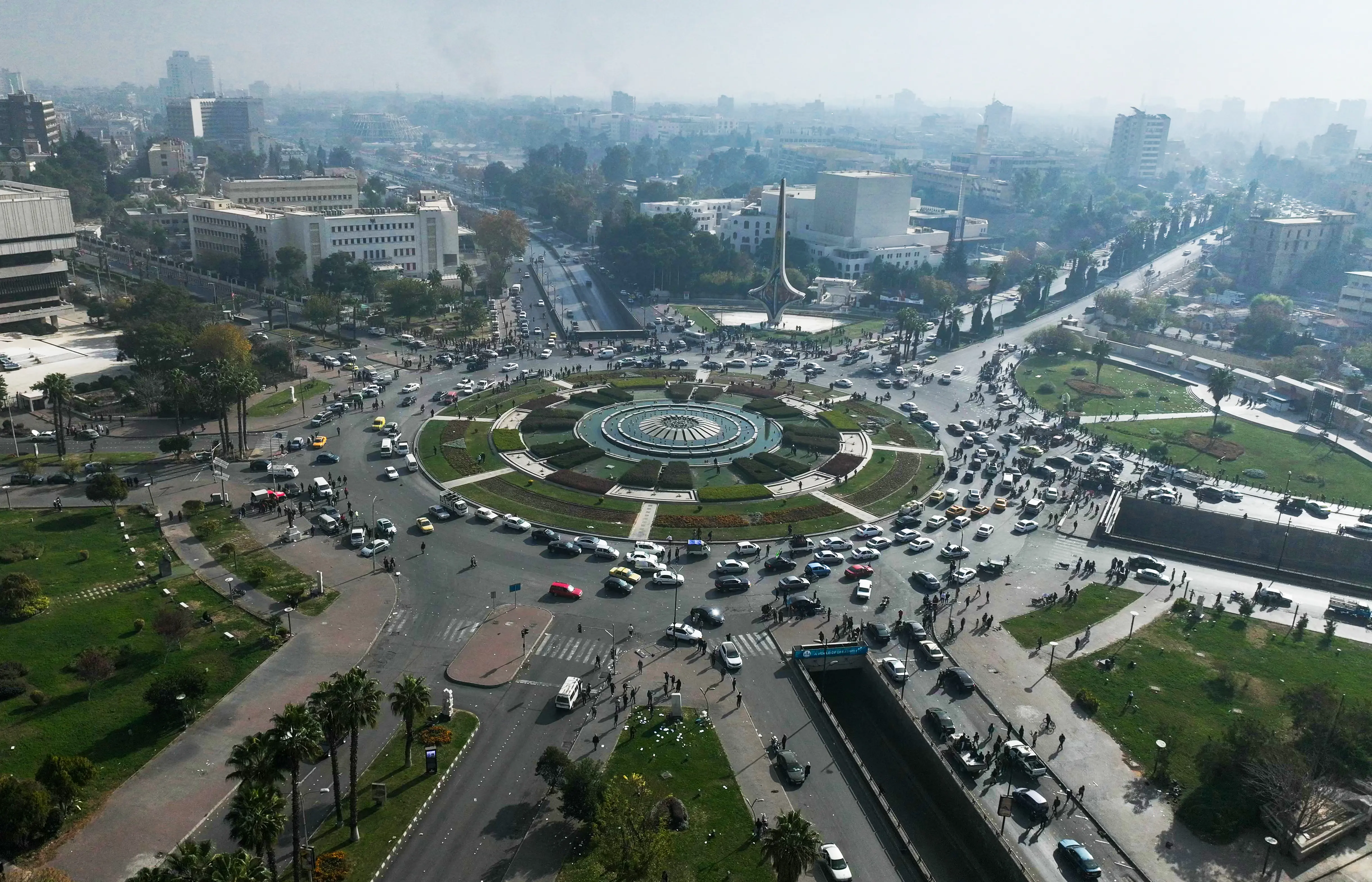 This aerial photo shows people gathering around Umayyad Square in Damascus