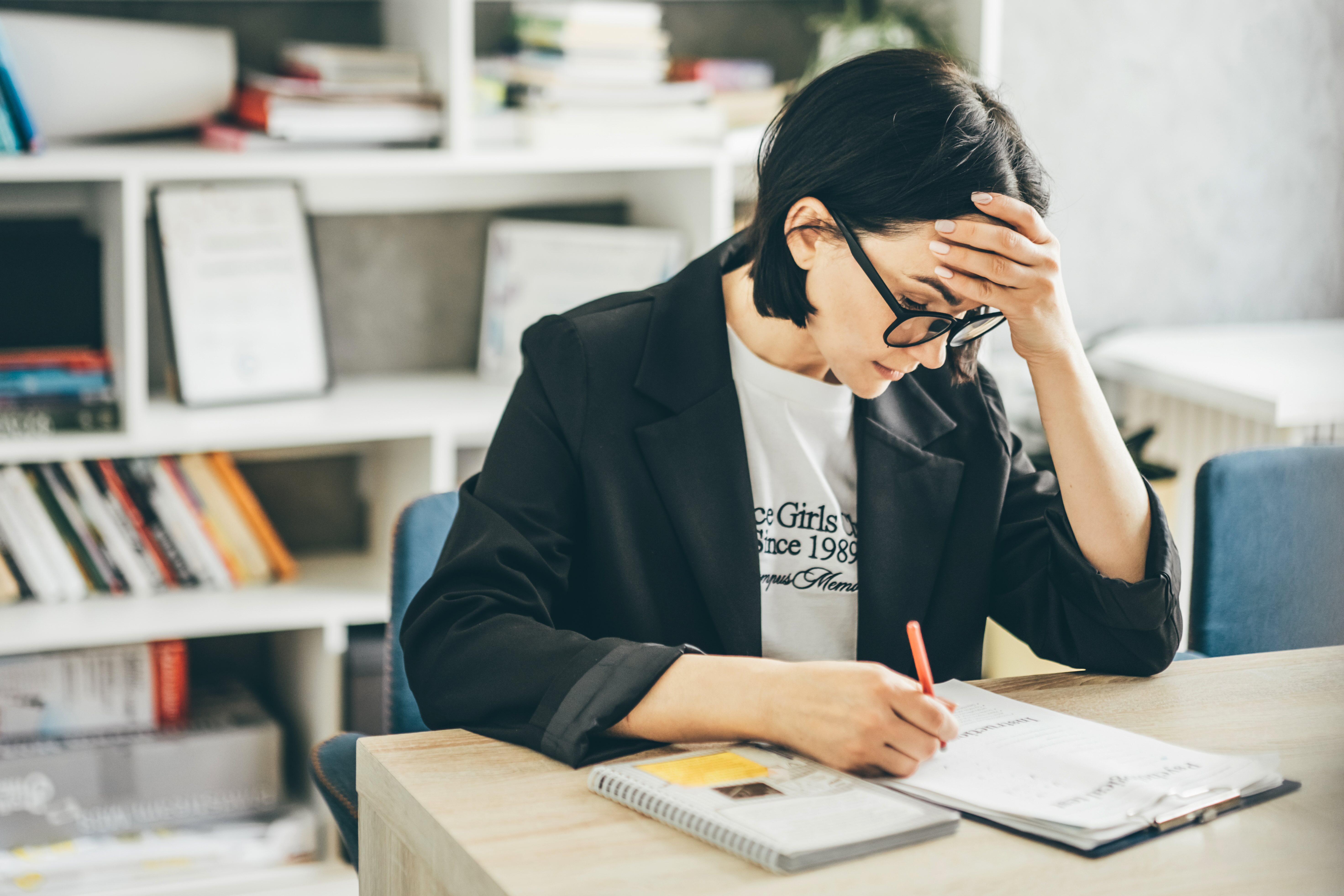 Overwhelmed teacher, hand on head