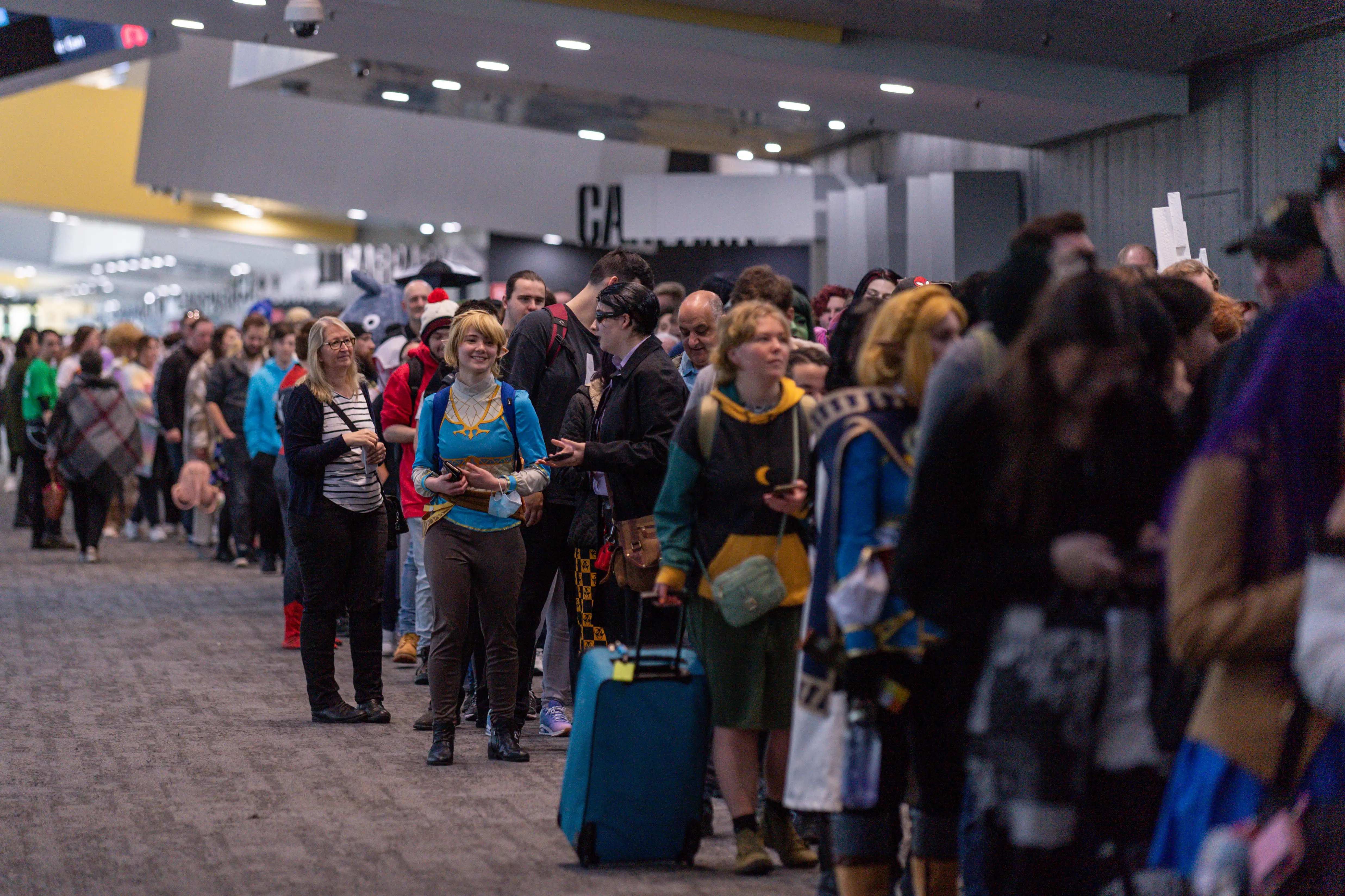 Gamers dress up in cosplay at a crowded gaming convention