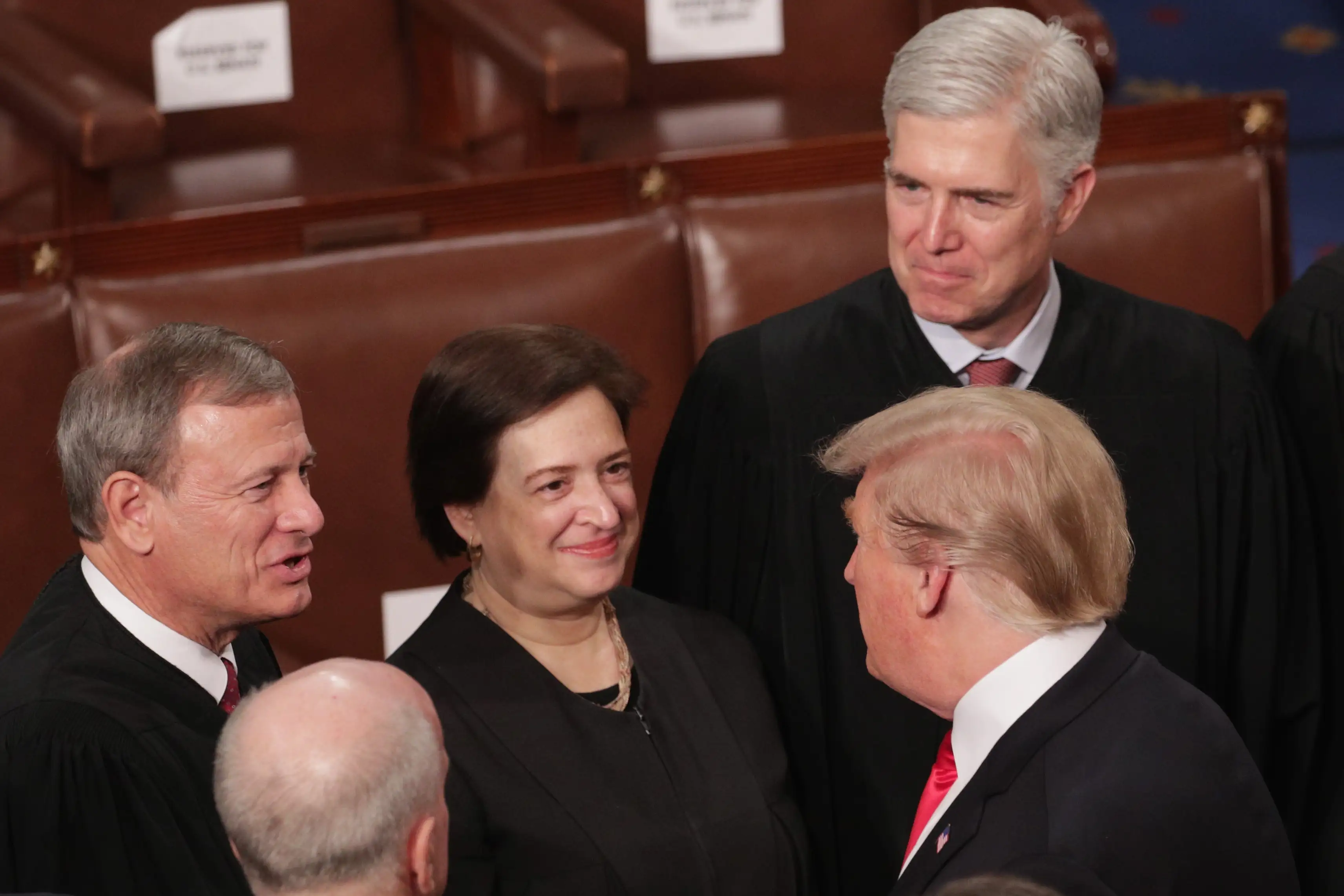 Donald Trump greets Supreme Court Justices John Roberts, Elena Kagan, and Neil Gorsuch.