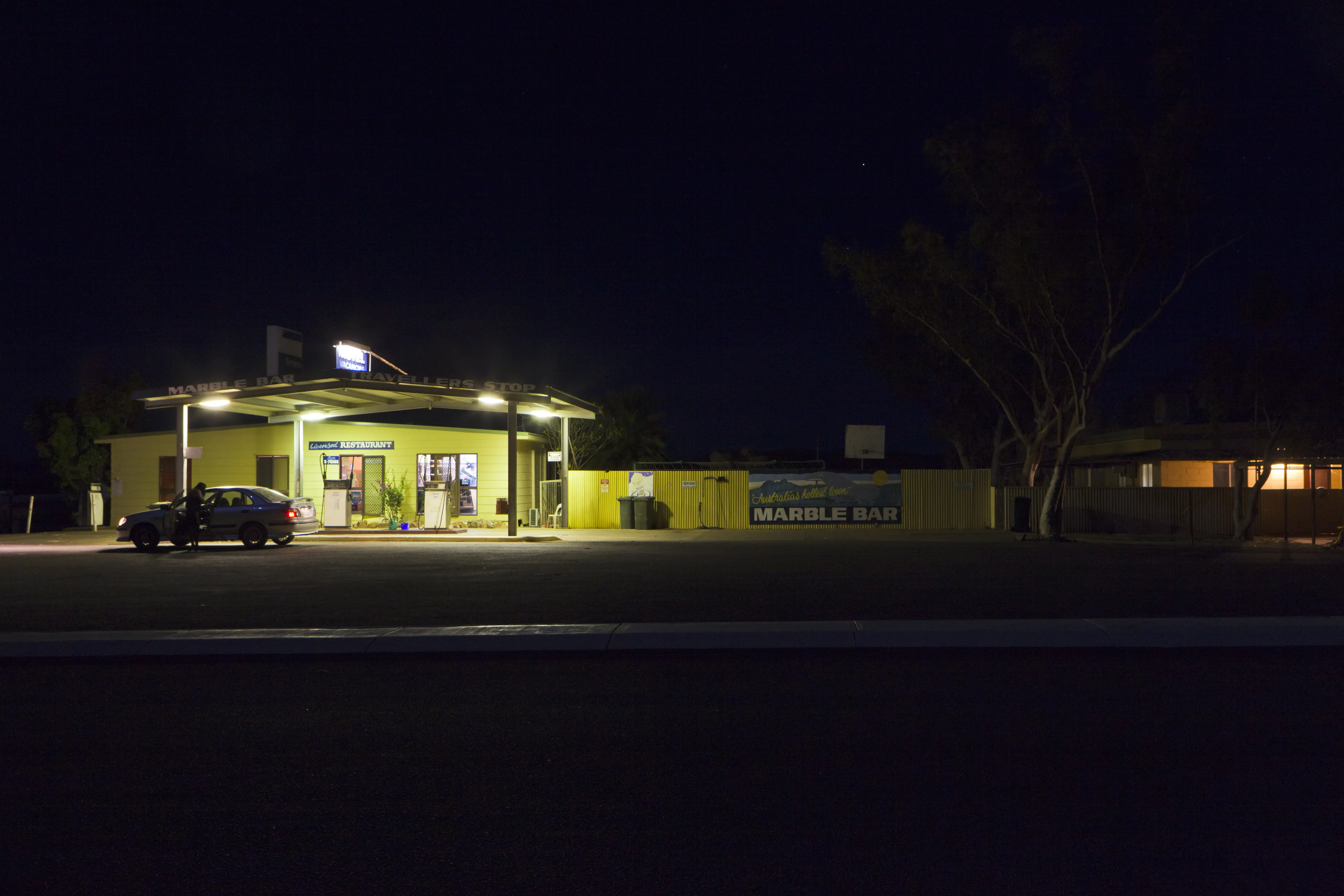 A car filling up at night in the remote town of Marble Bar in Western Australia