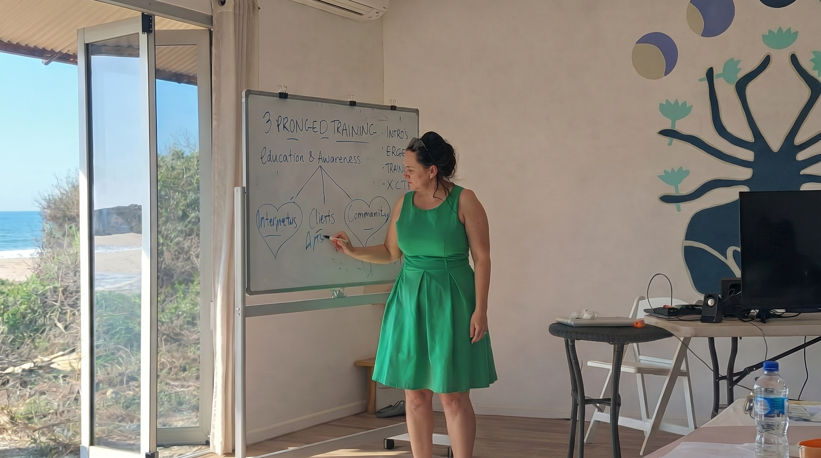 Deanne Lightfoot, CEO of Aboriginal Interpreting WA, writes on a whiteboard during one of the workshops in Broome