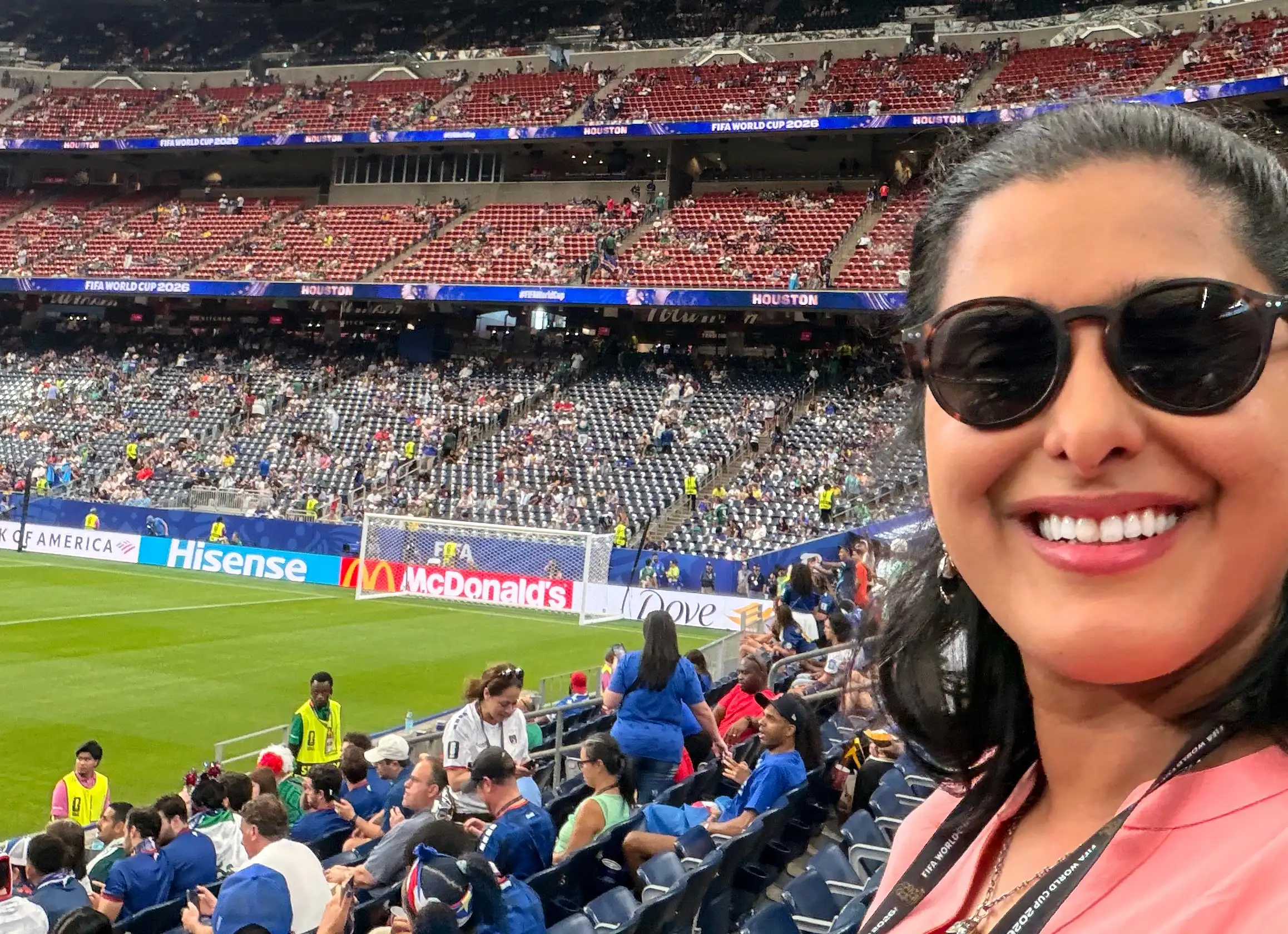 A photo of Aish Ravi smiling in the stands at the World Cup