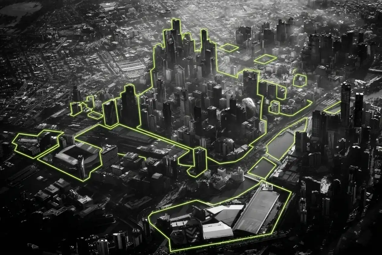 A black-and-white tilt shift photo of Melbourne from above with elements picked out in lime green