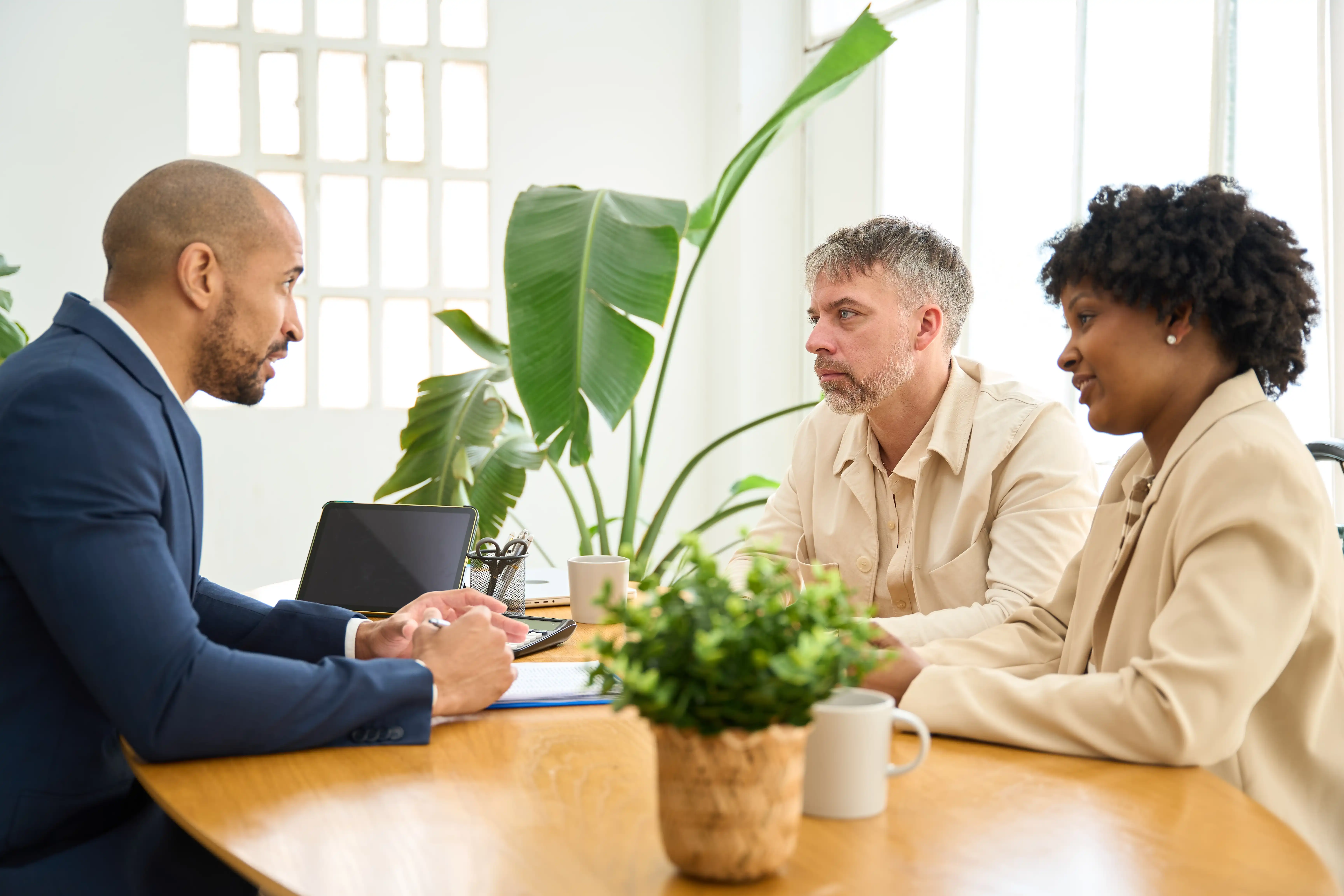 Financial advisor speaking to a couple at a desk