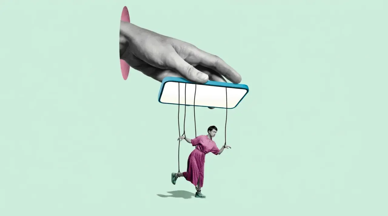 A graphic of a large hand holding a mobile phone with puppet strings attached to a figure