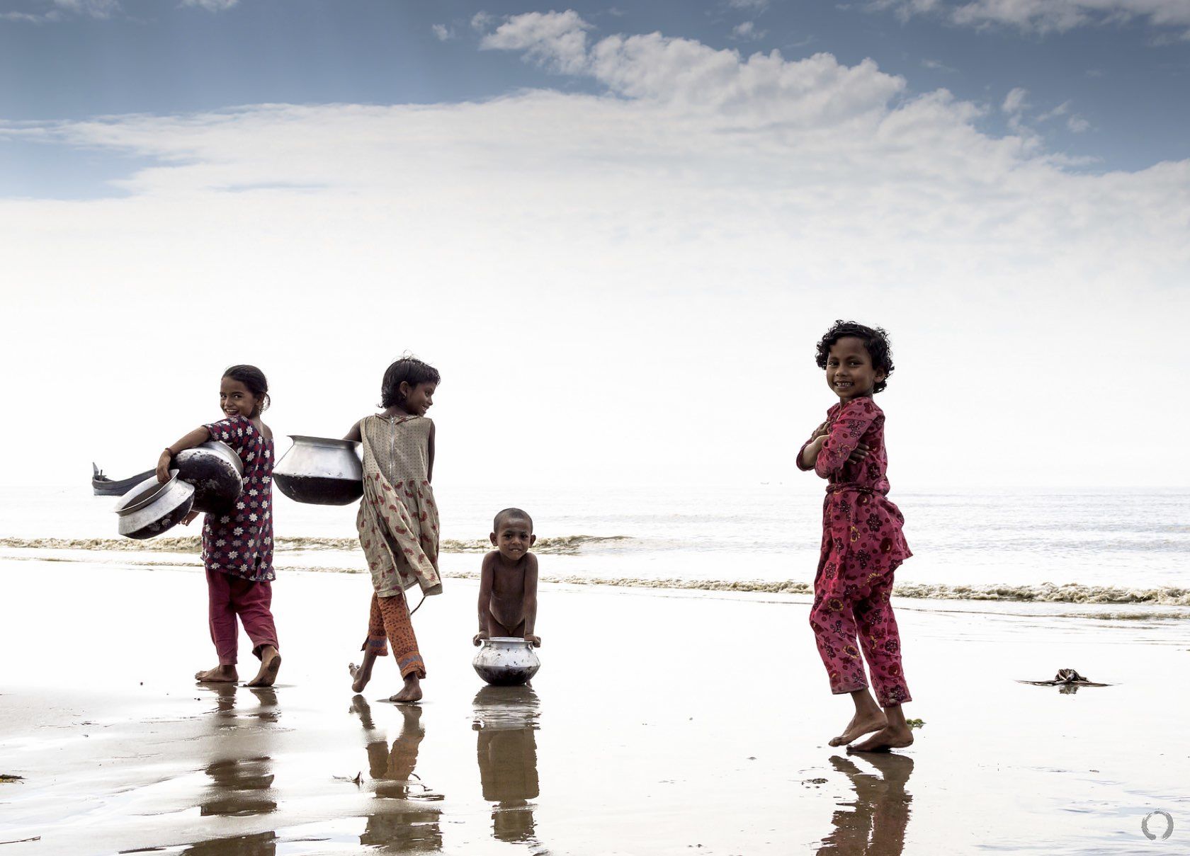 Children playing next to the water. 