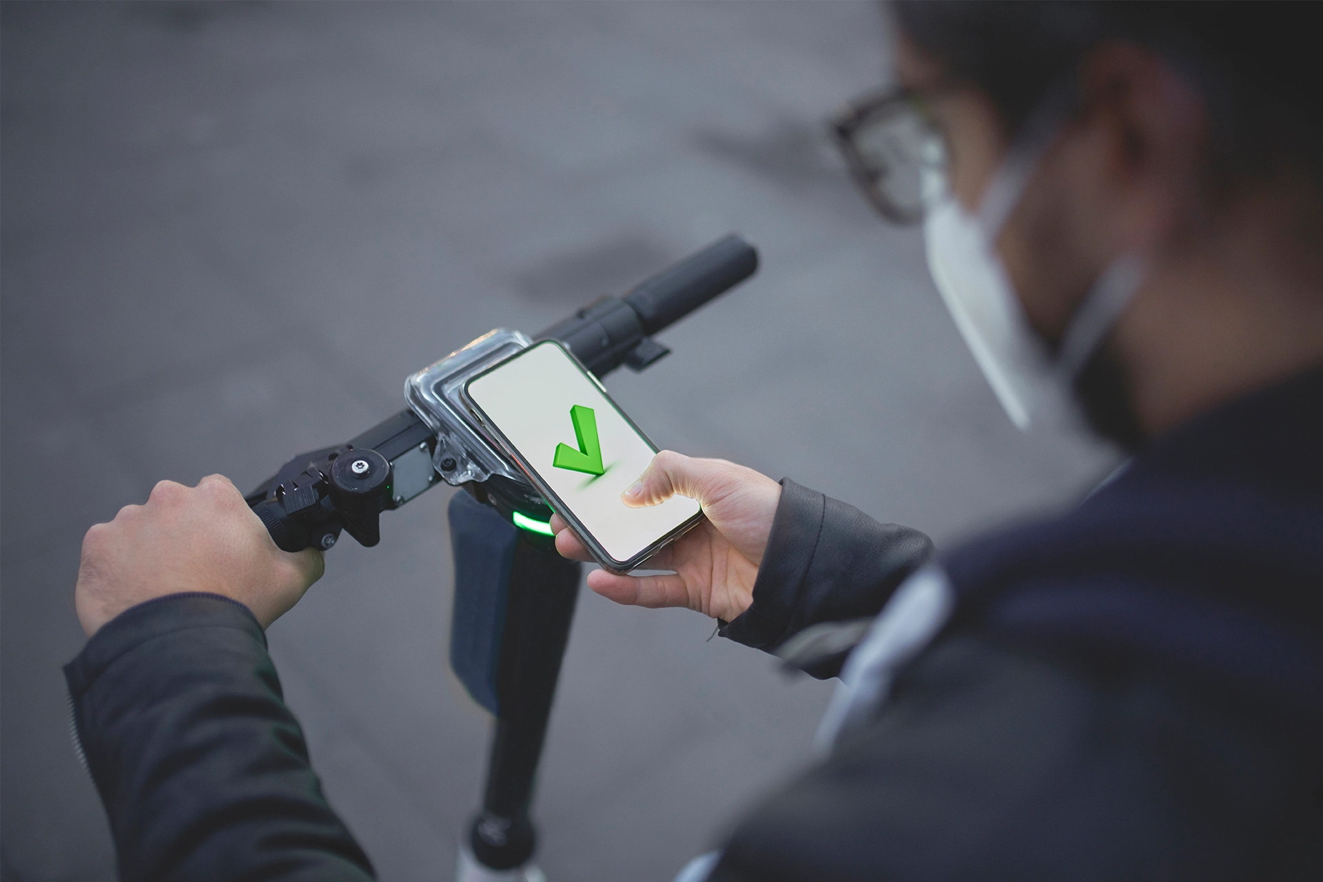 Man booking a shared e-scooter using a mobile phone app